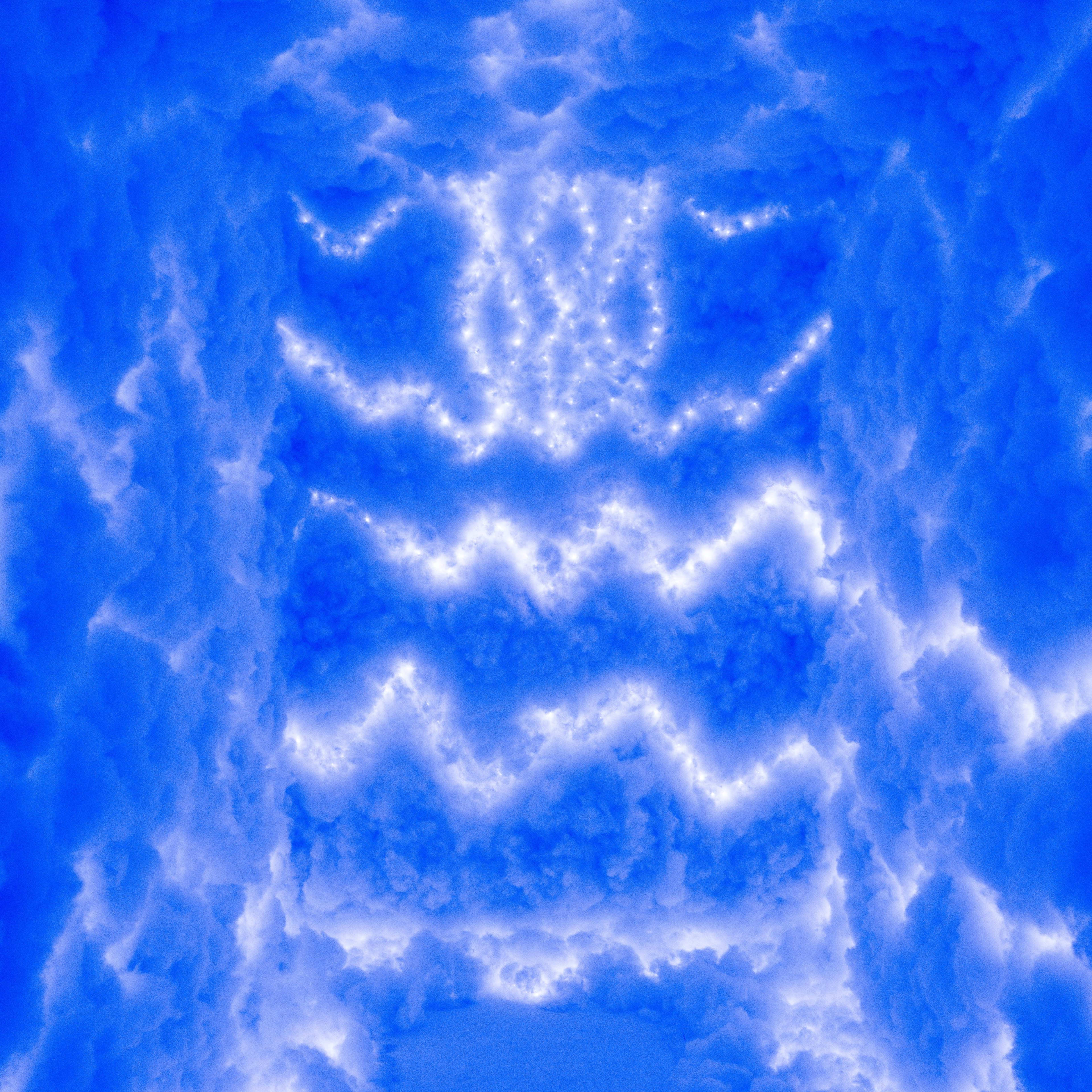 A vibrant blue sky filled with fluffy white clouds illuminated by bright light.
