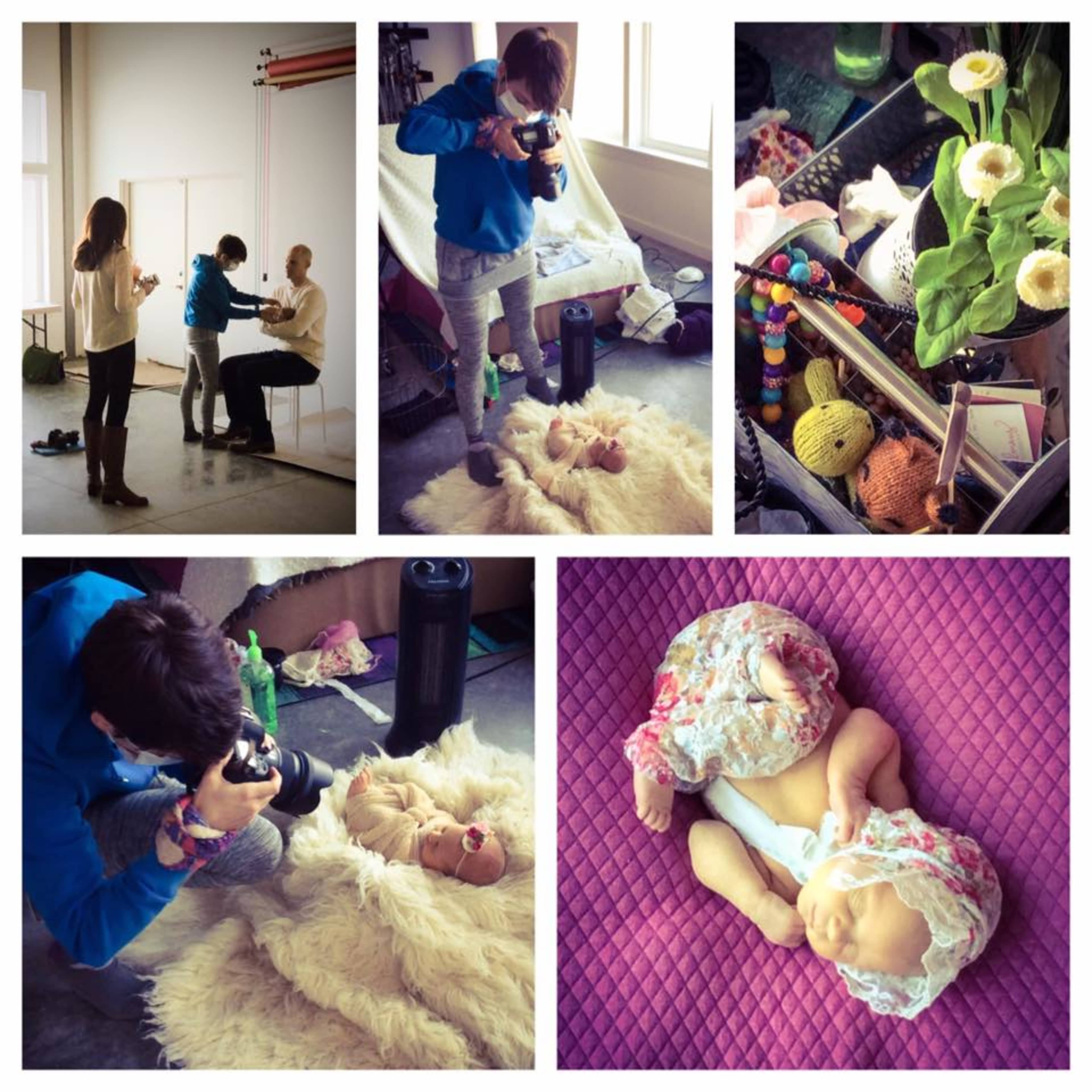 A photographer captures images of a doll lying on a fur rug while a couple poses for pictures nearby in a well-lit studio space.