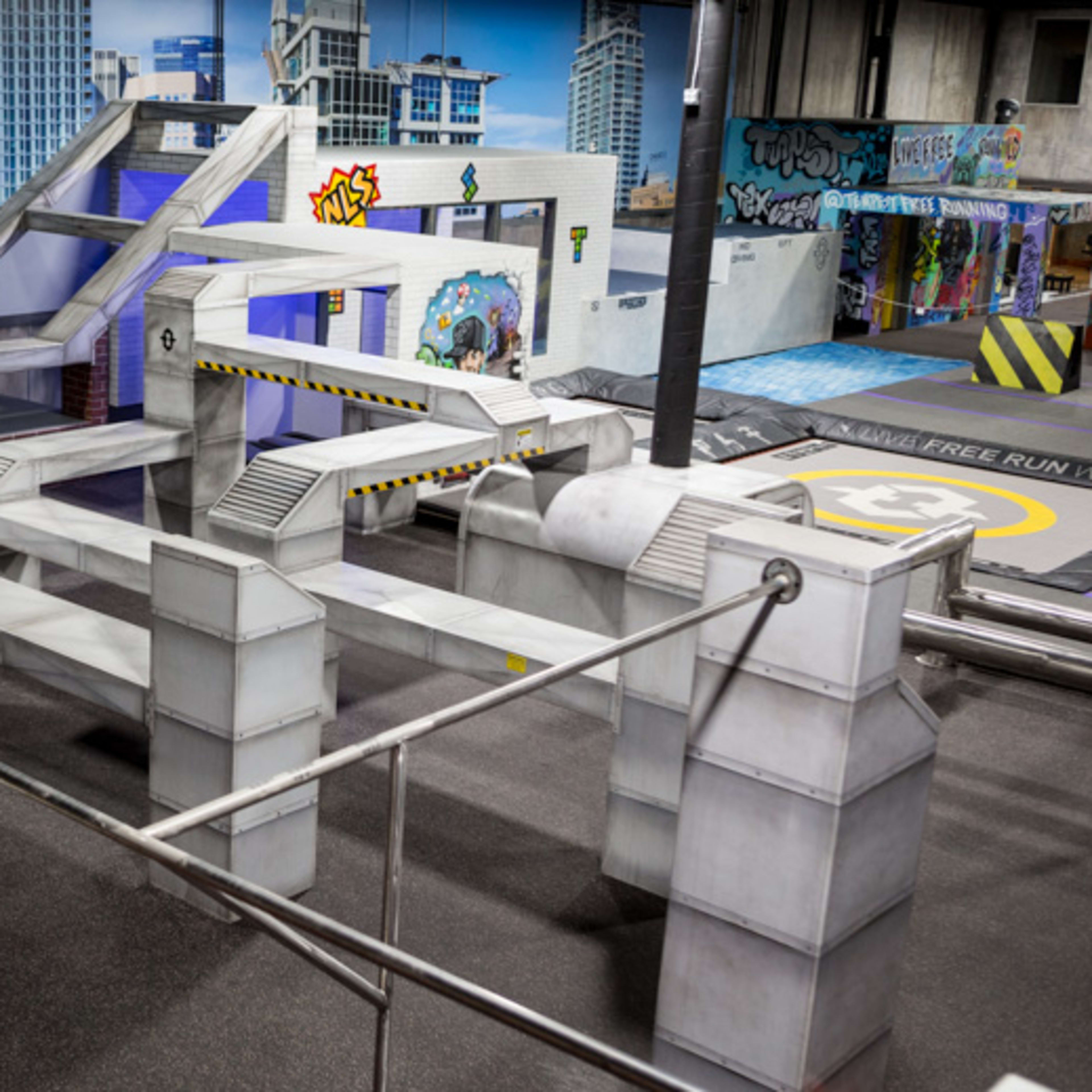 A geometric parkour training area with various levels and obstacles designed for urban-style movement.