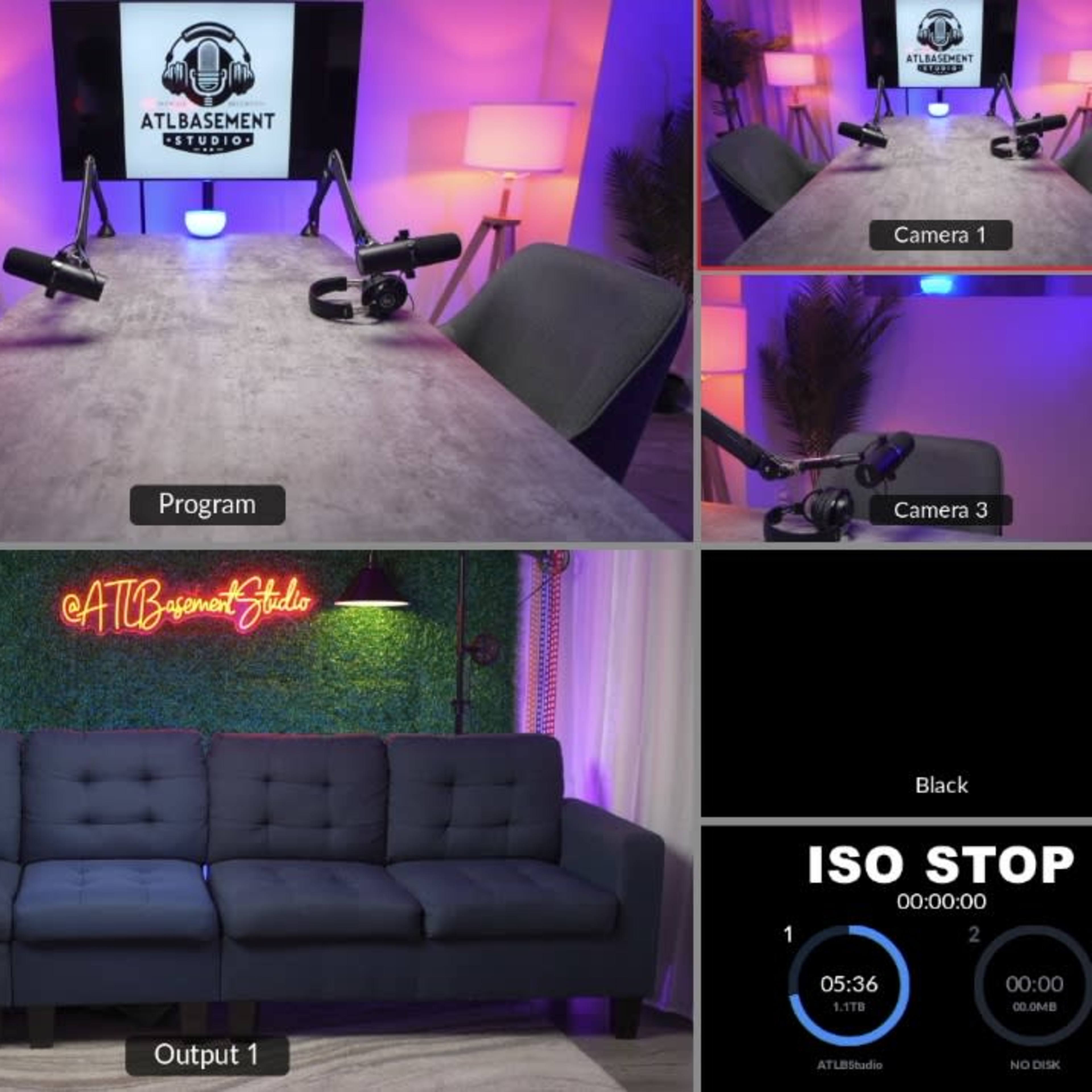 A multi-camera setup for a recording studio, featuring a couch, microphones, and a neon sign in a well-lit environment.