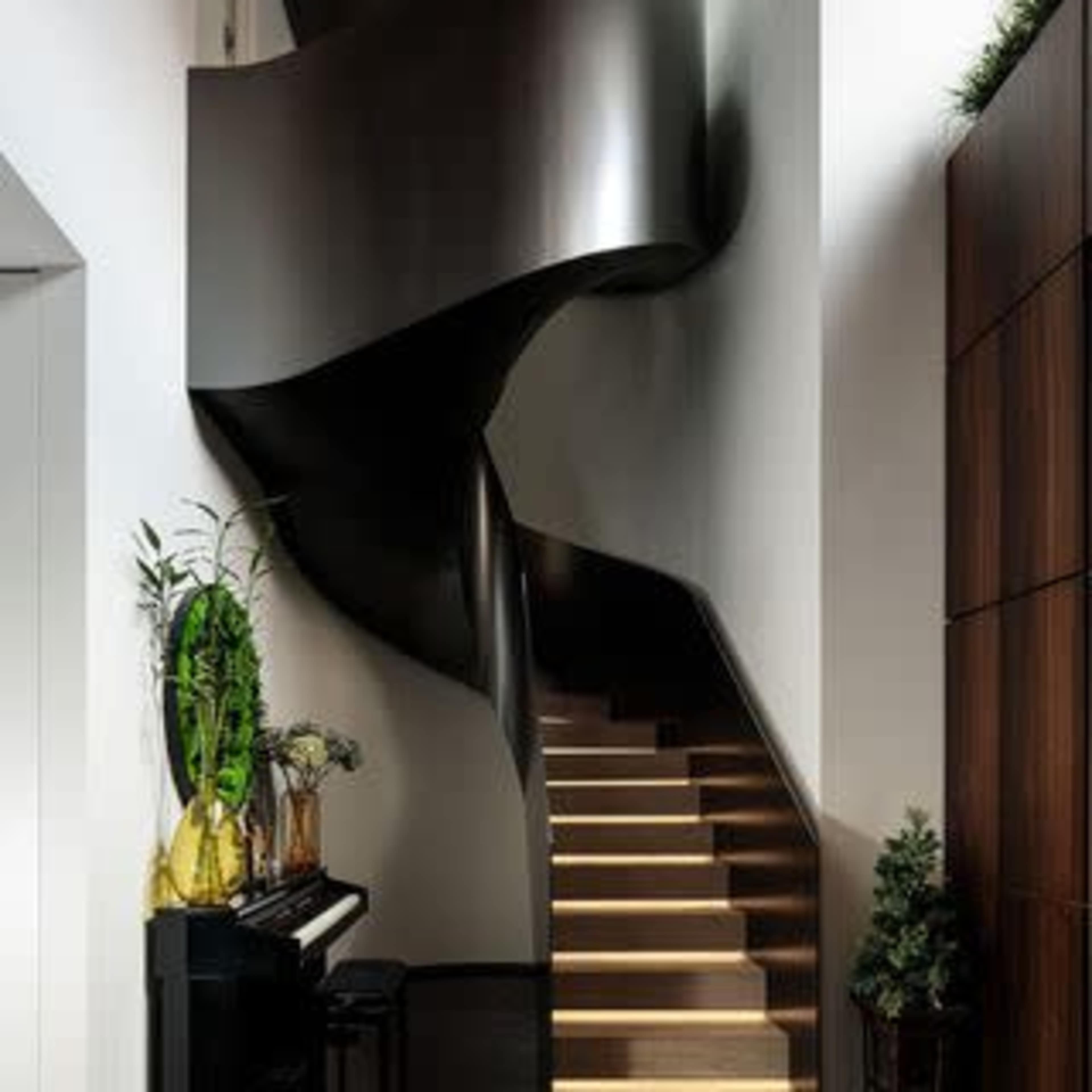 A modern, spiral staircase adjacent to a black piano in a house with sleek architectural lines and minimalistic decor.