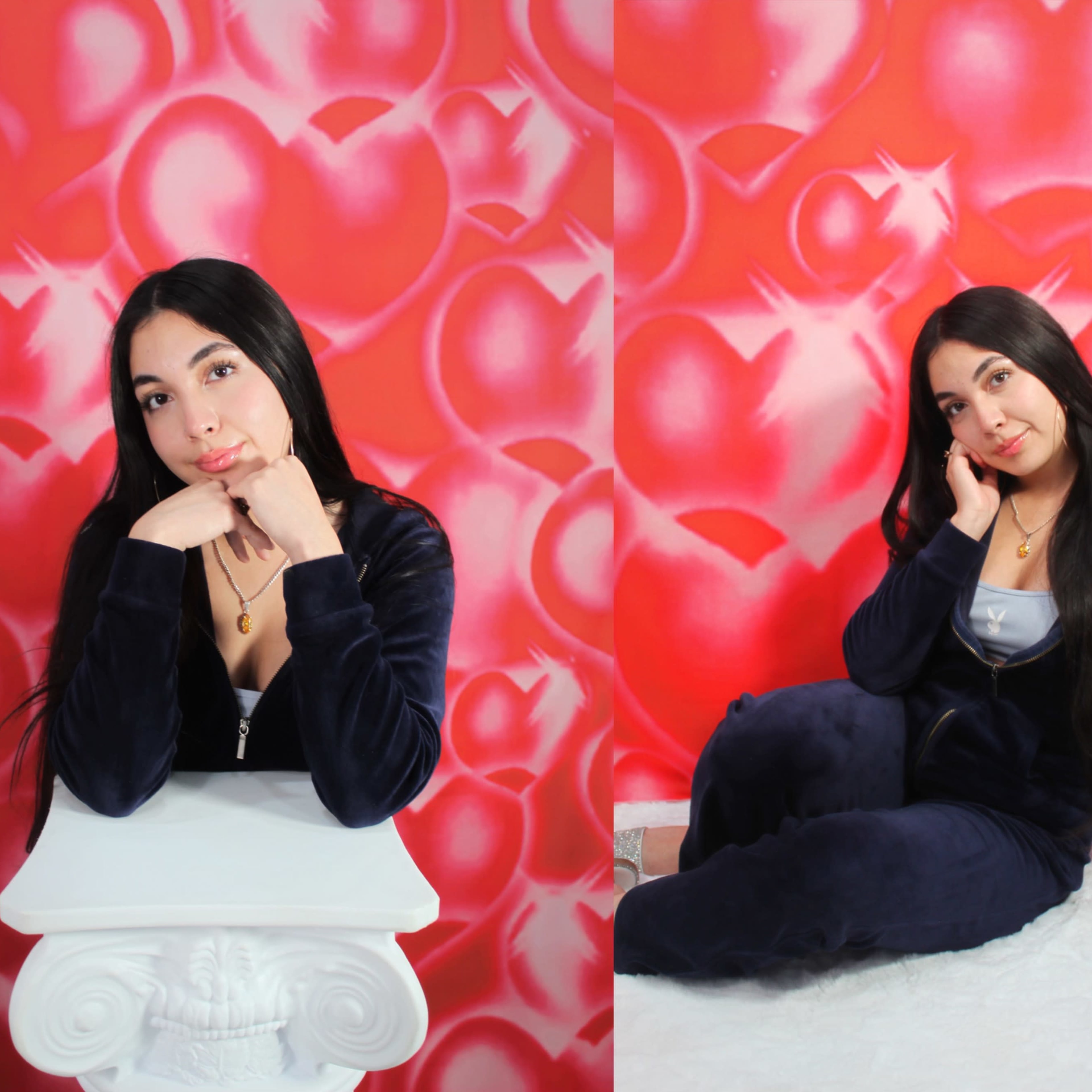 A woman poses with her chin resting on her hand against a brightly colored heart-patterned background.