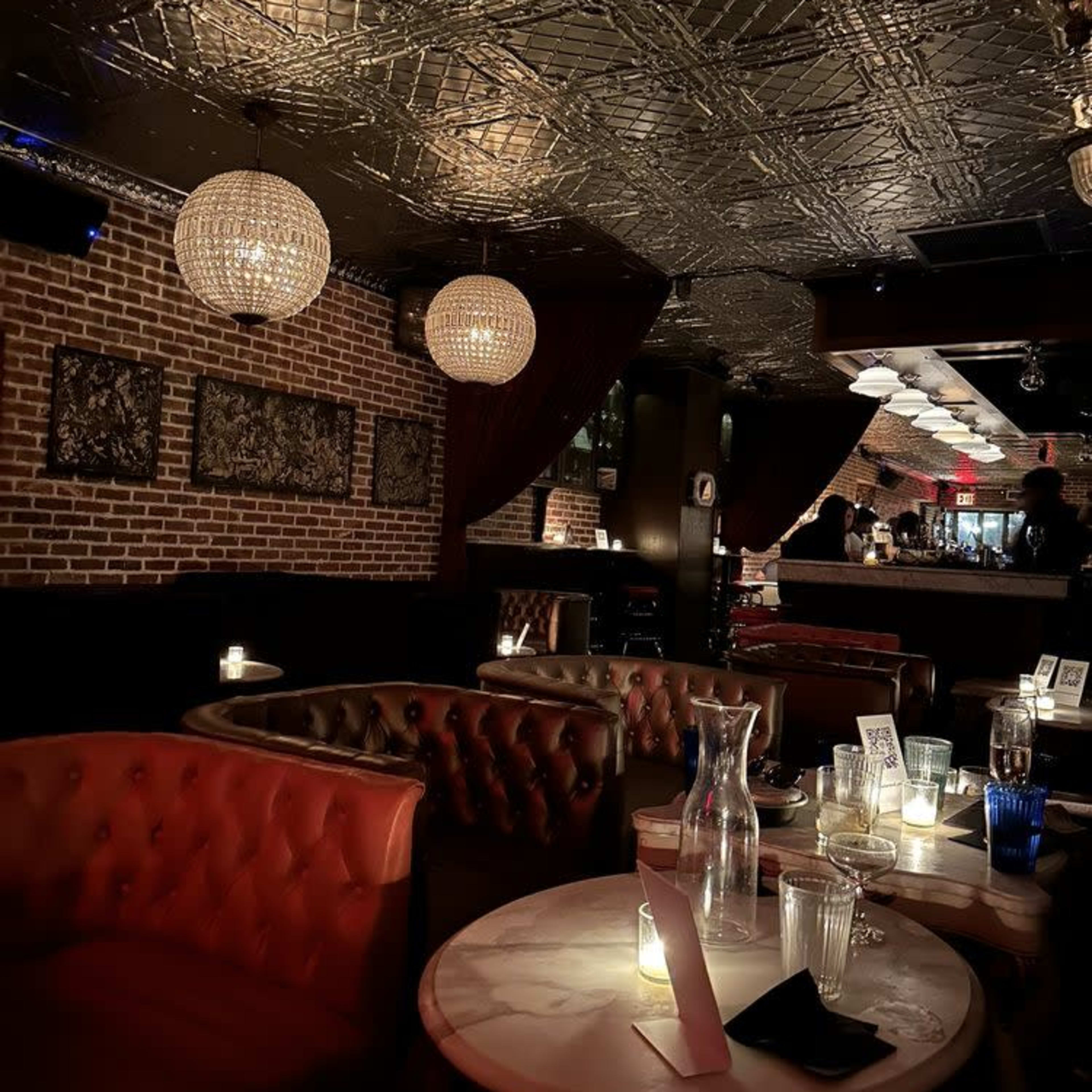 An upscale lounge with plush seating, a marble table, and decorative lighting.