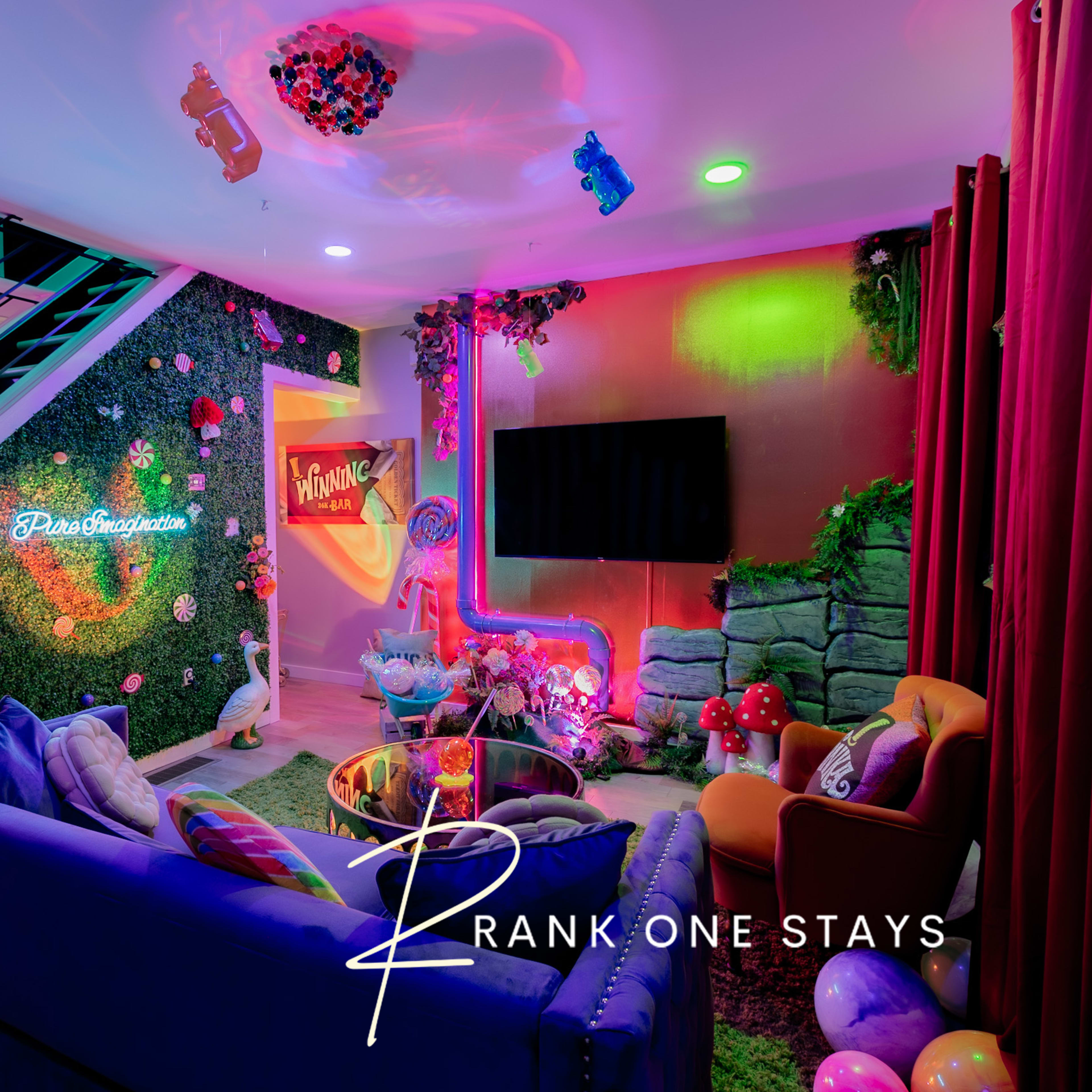 A vibrant and colorful entertainment area features a mix of seating arrangements, decorative plants, and modern lighting.