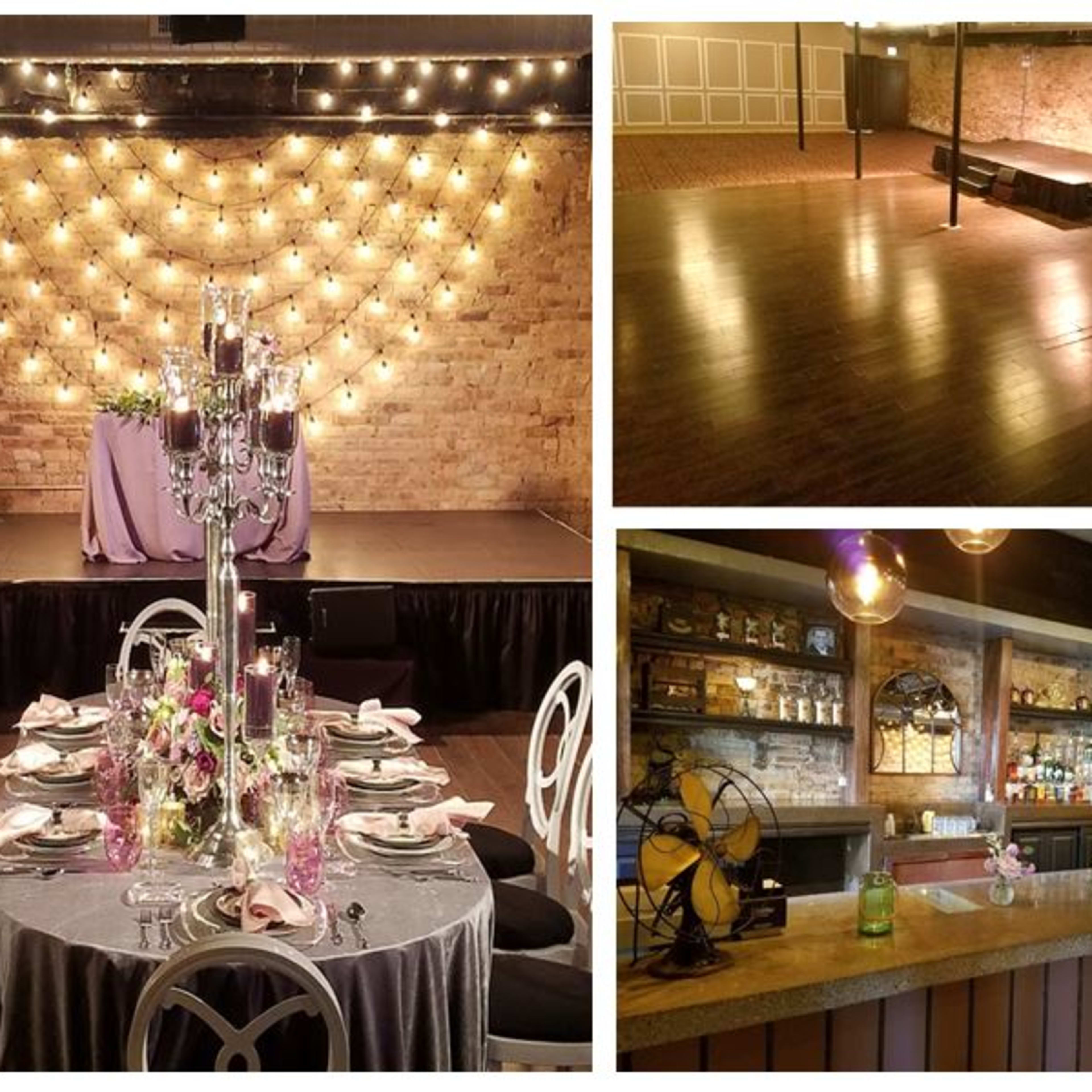 A venue featuring a decorated dining area with elegant table settings, a spacious dance floor with a stage, and a bar area with various bottles on display against a brick backdrop.