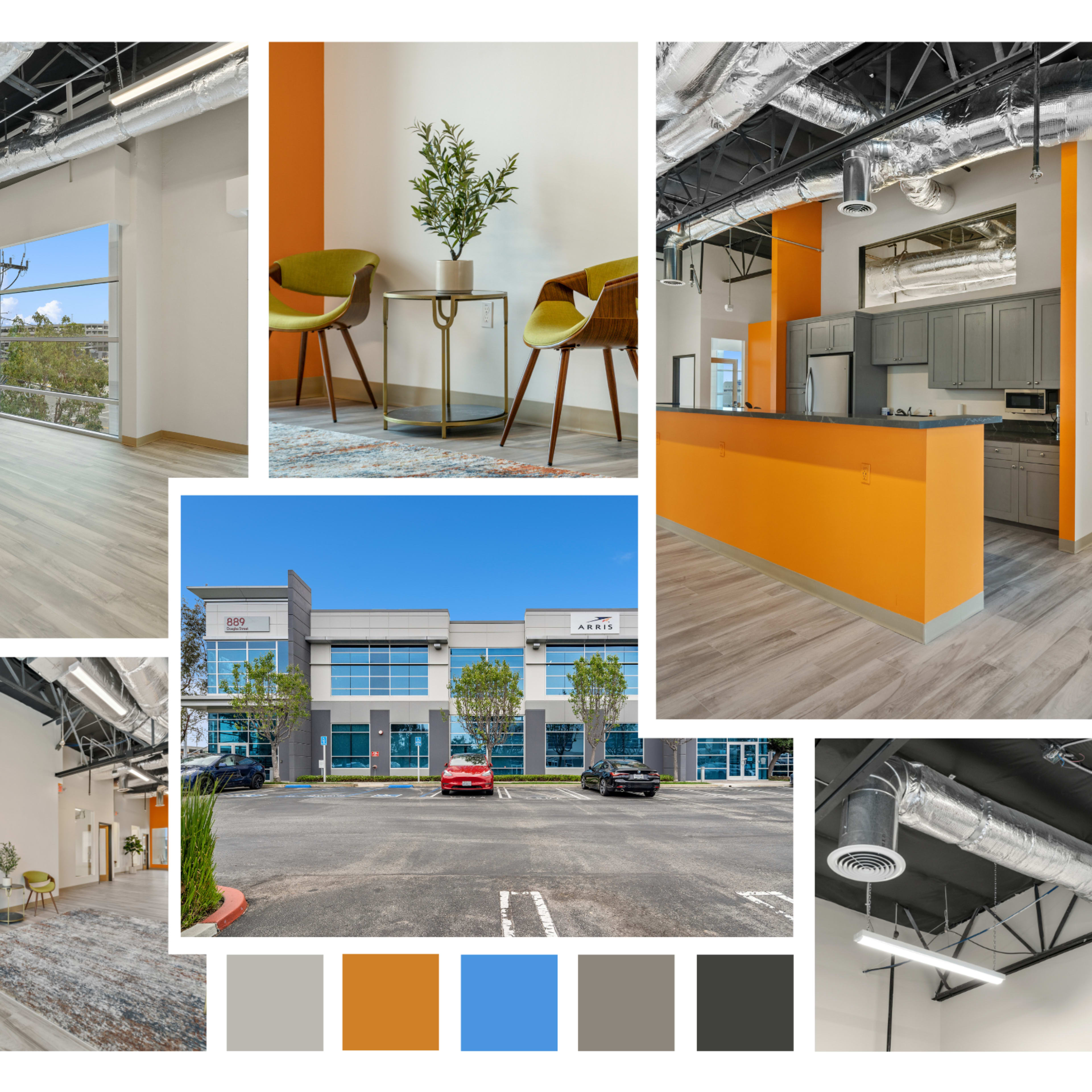 A modern office space featuring large windows, contemporary furniture, and an orange accent wall.
