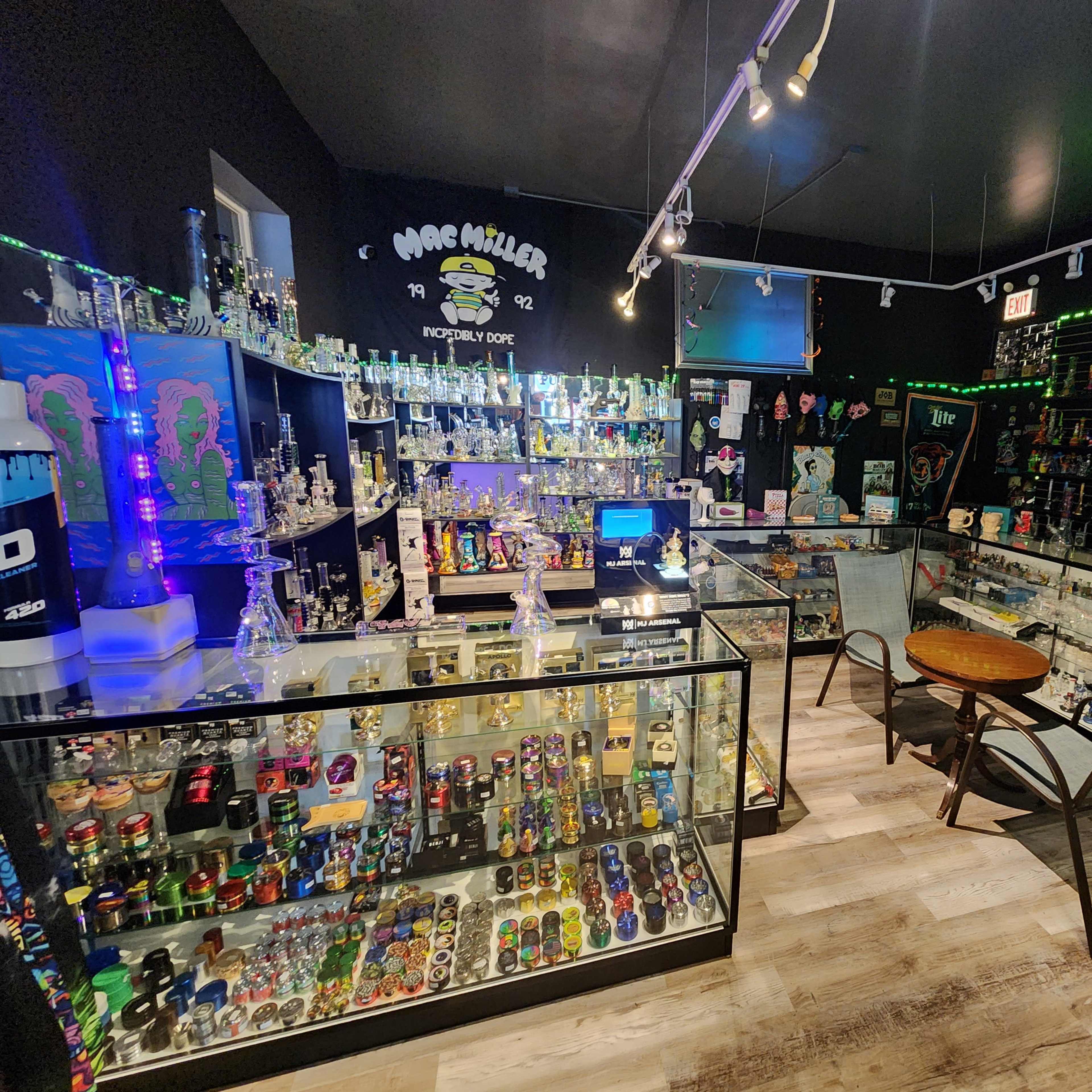An interior of a smoke shop filled with various glassware and smoking accessories, displayed in glass cases and on shelves.