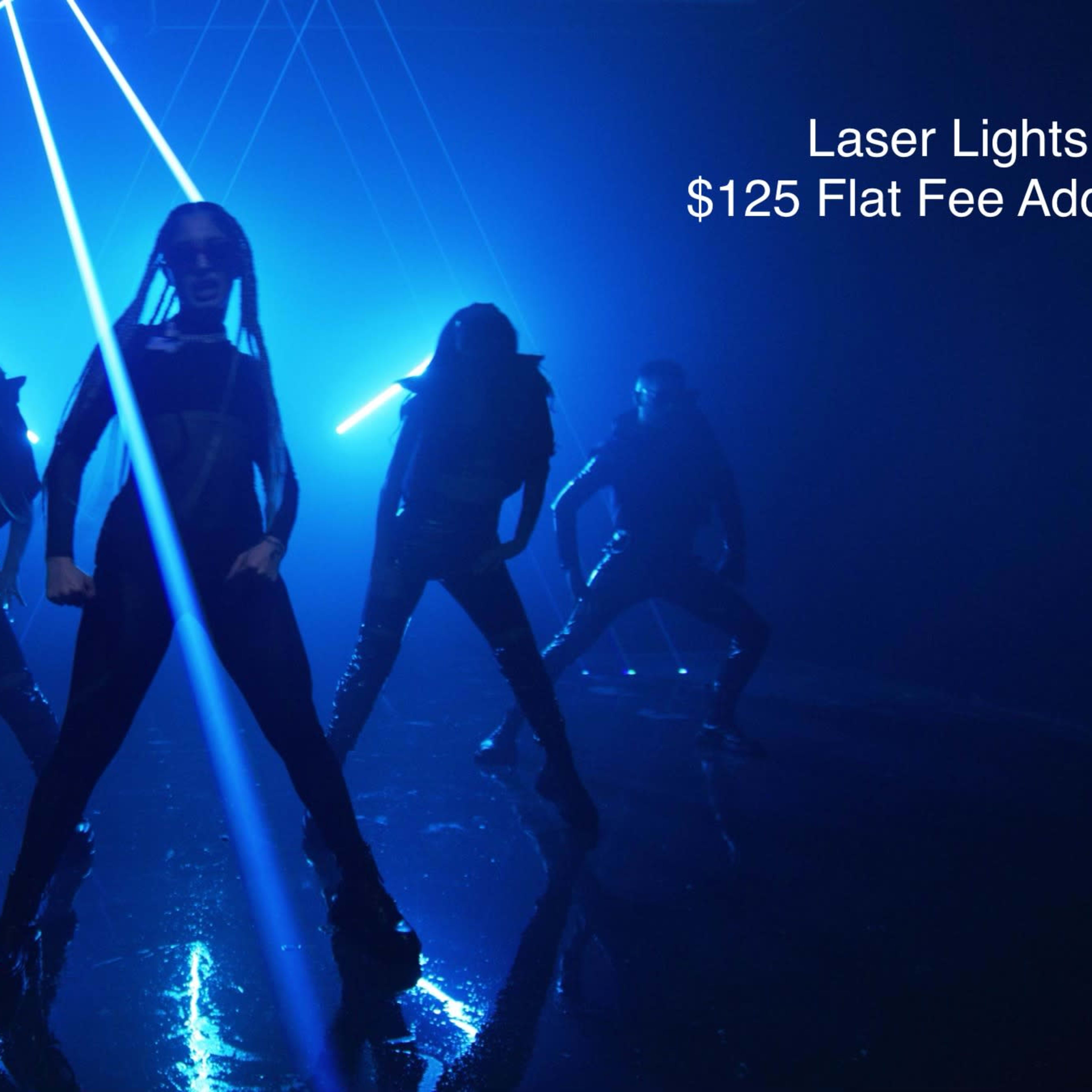 A group of dancers performs under blue laser lights in a dimly lit space.