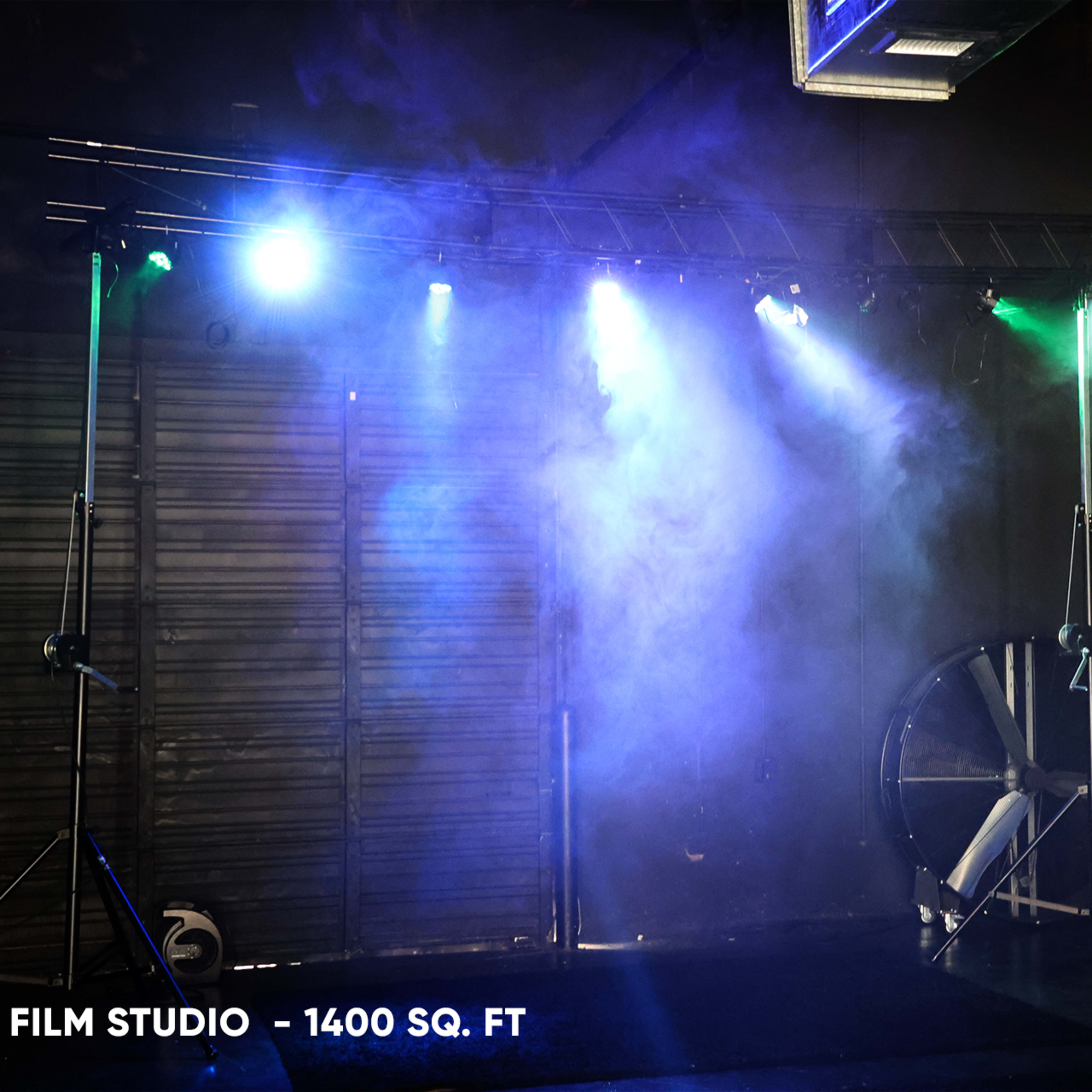 A film studio setup with lighting equipment and a large fan in a space measuring 1400 square feet.