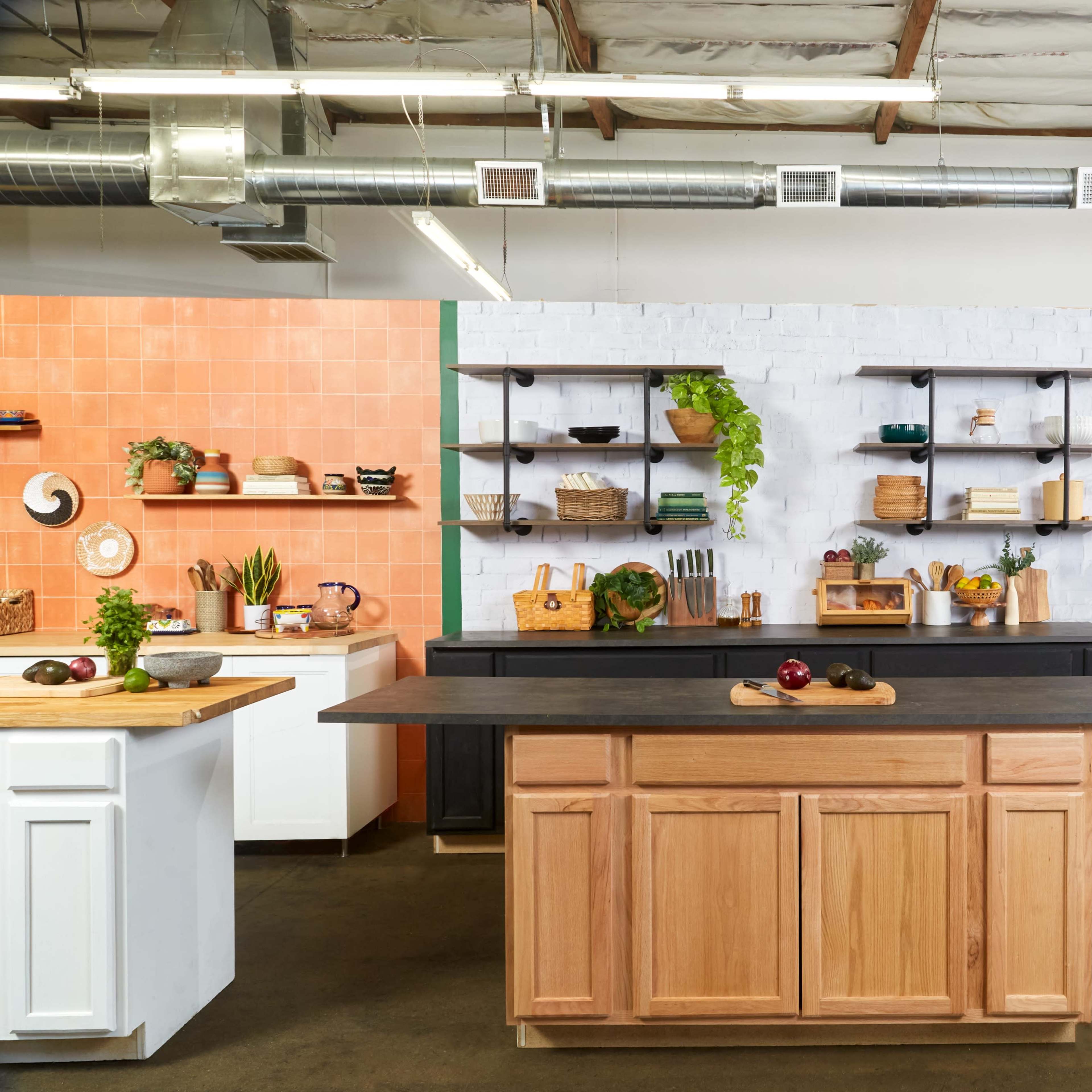 A modern kitchen with a central island, open shelving, and stainless steel appliances in a spacious, well-lit environment.