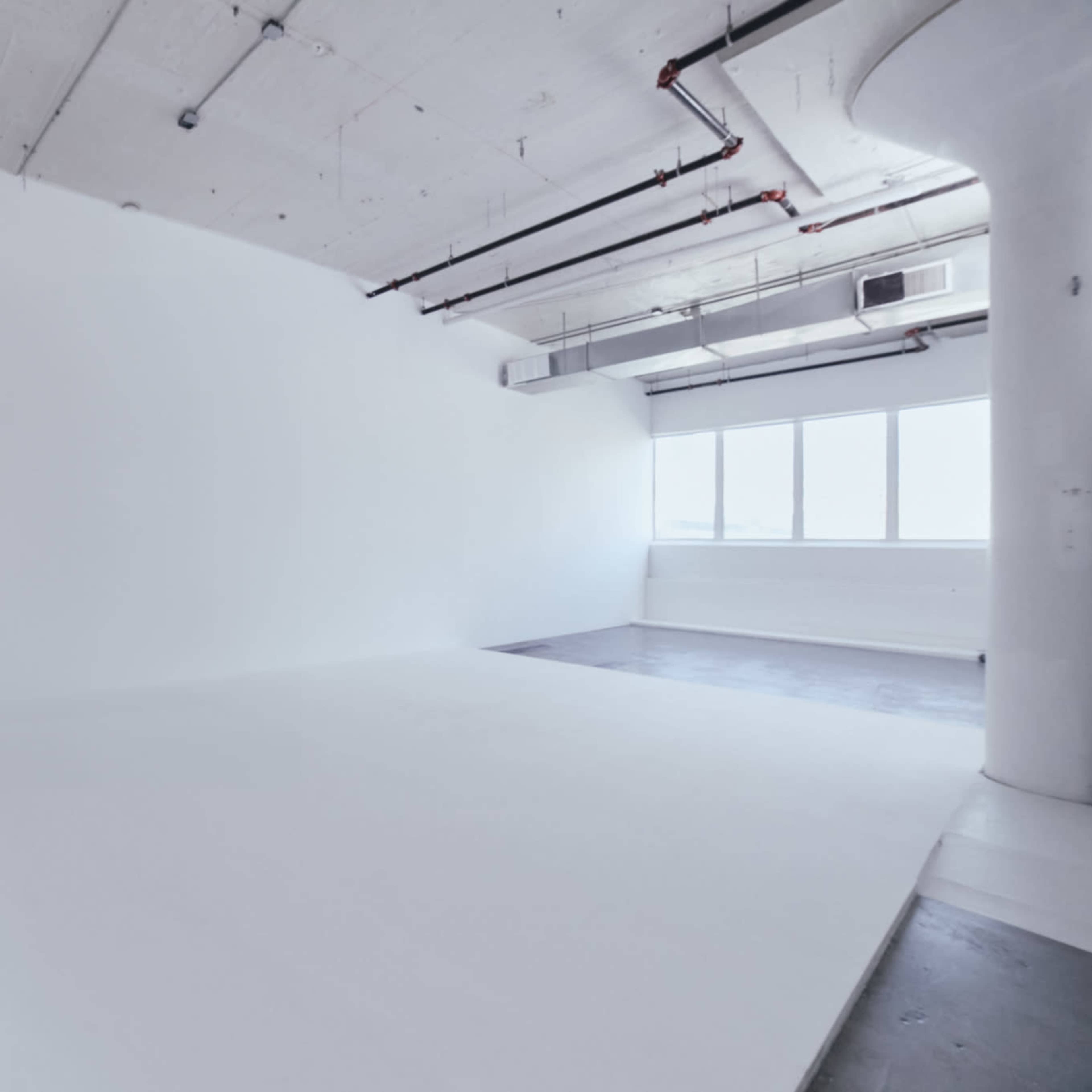All white photo/video studio with CYC wall and concrete floors. White Rabbit Studio Image in Long Island City, Queens County, NY