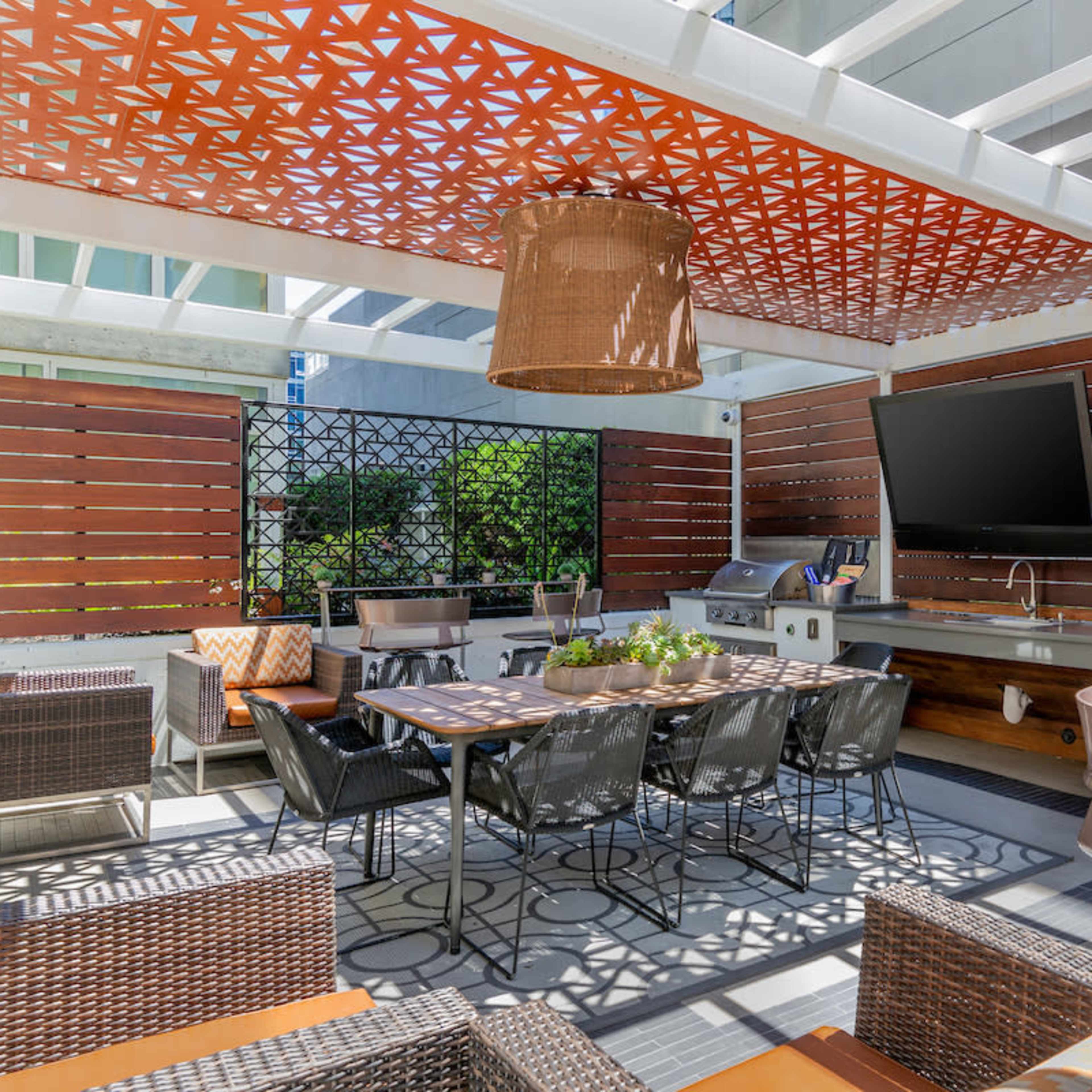 A well-lit lounge area featuring a billiard table, large windows, and modern furnishings.