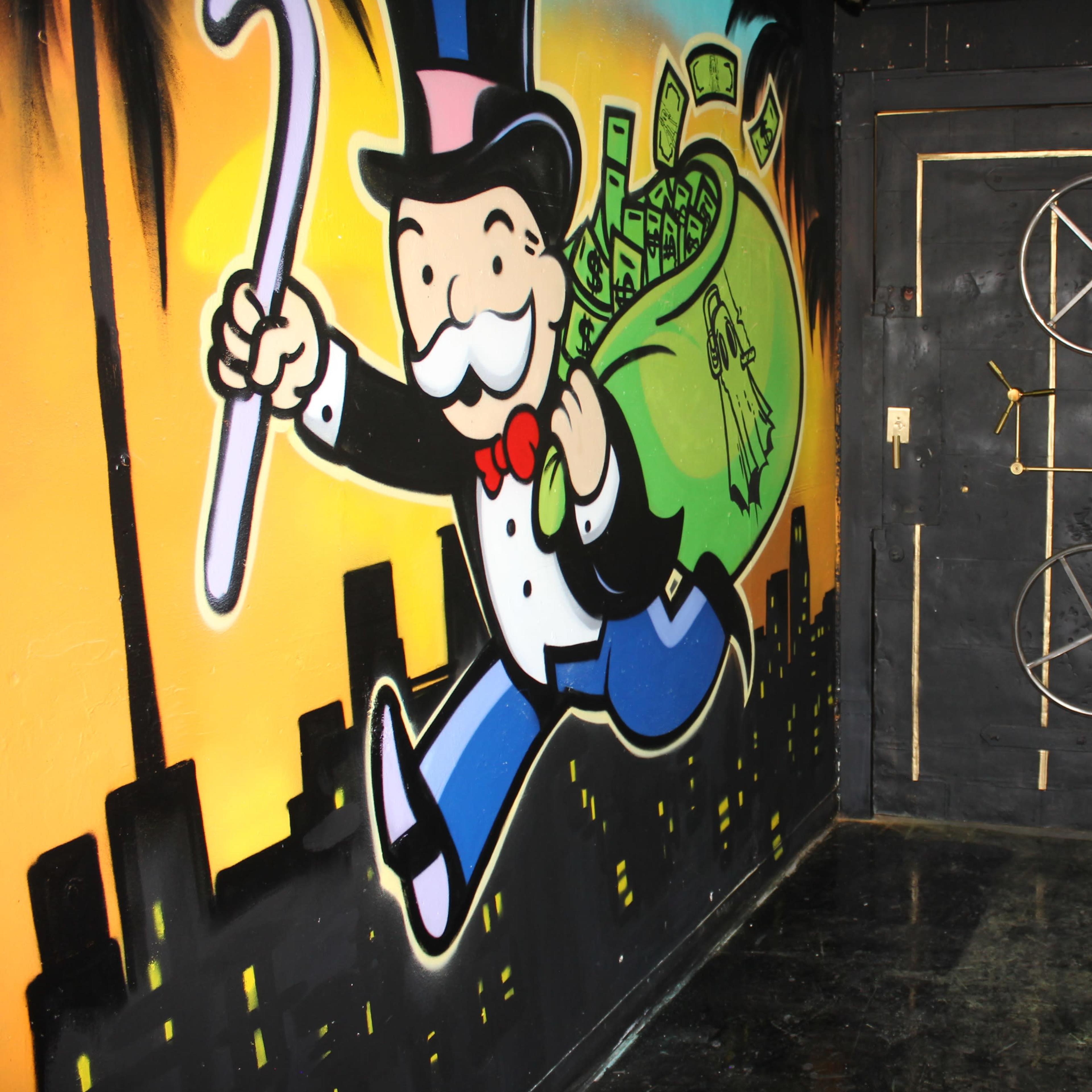 A vibrant mural of a man in a top hat carrying a bag of money next to a door featuring a circular design and a pentagram.