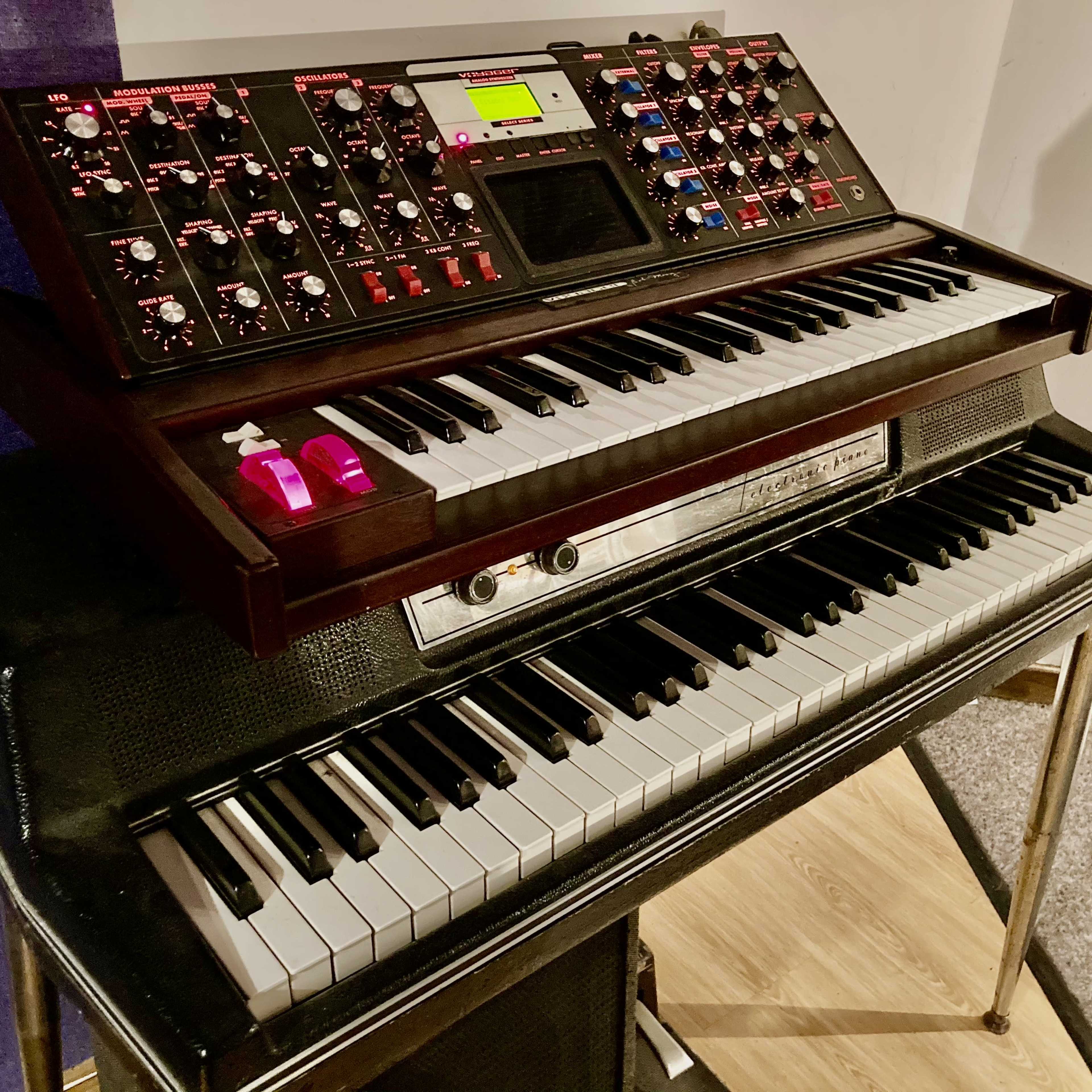 A two-tier keyboard setup featuring a synthesizer on top and a digital piano on the bottom.