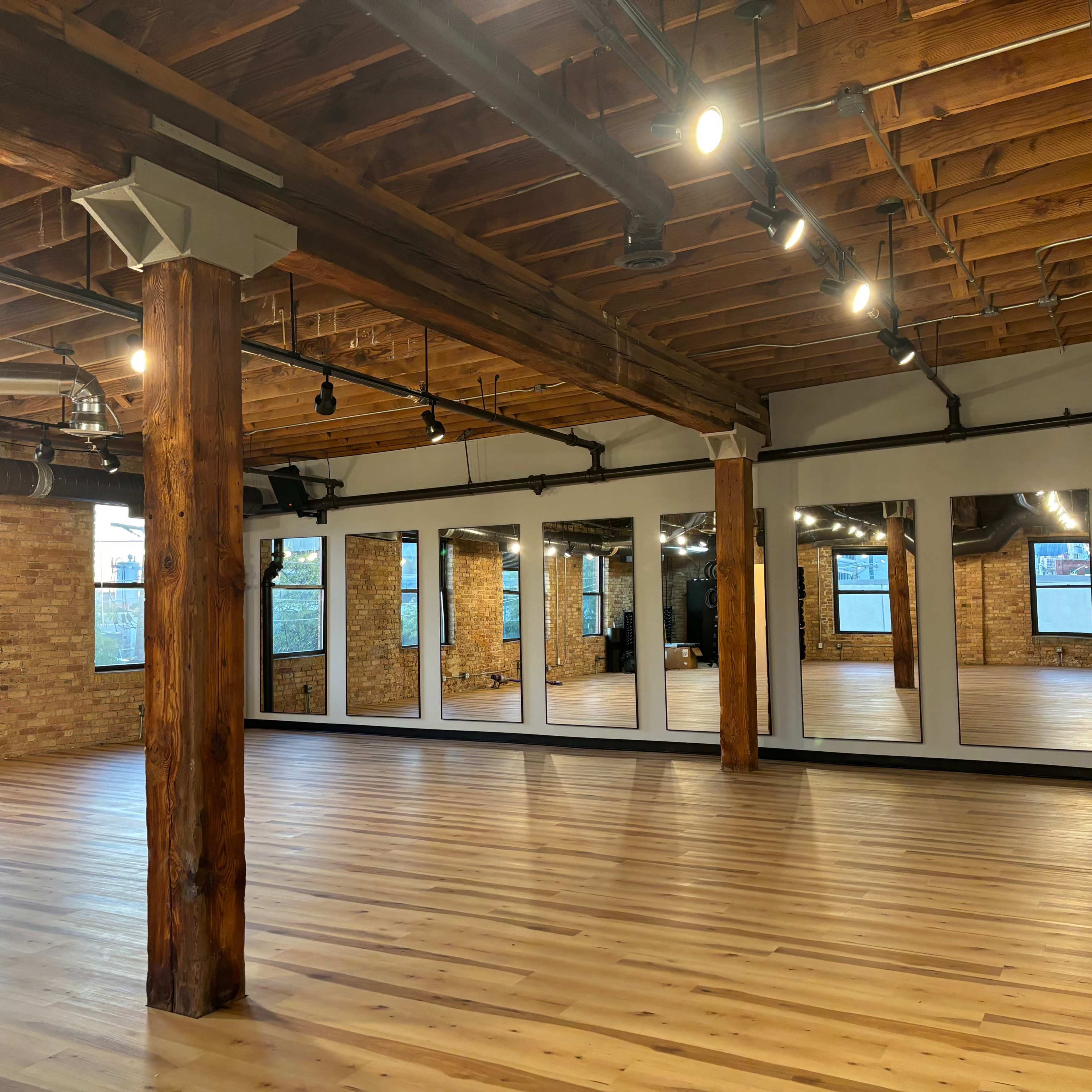 Beautiful timber loft fitness studio with equipment, skyline view and outdoor space. Image in Near North Side, Chicago, IL