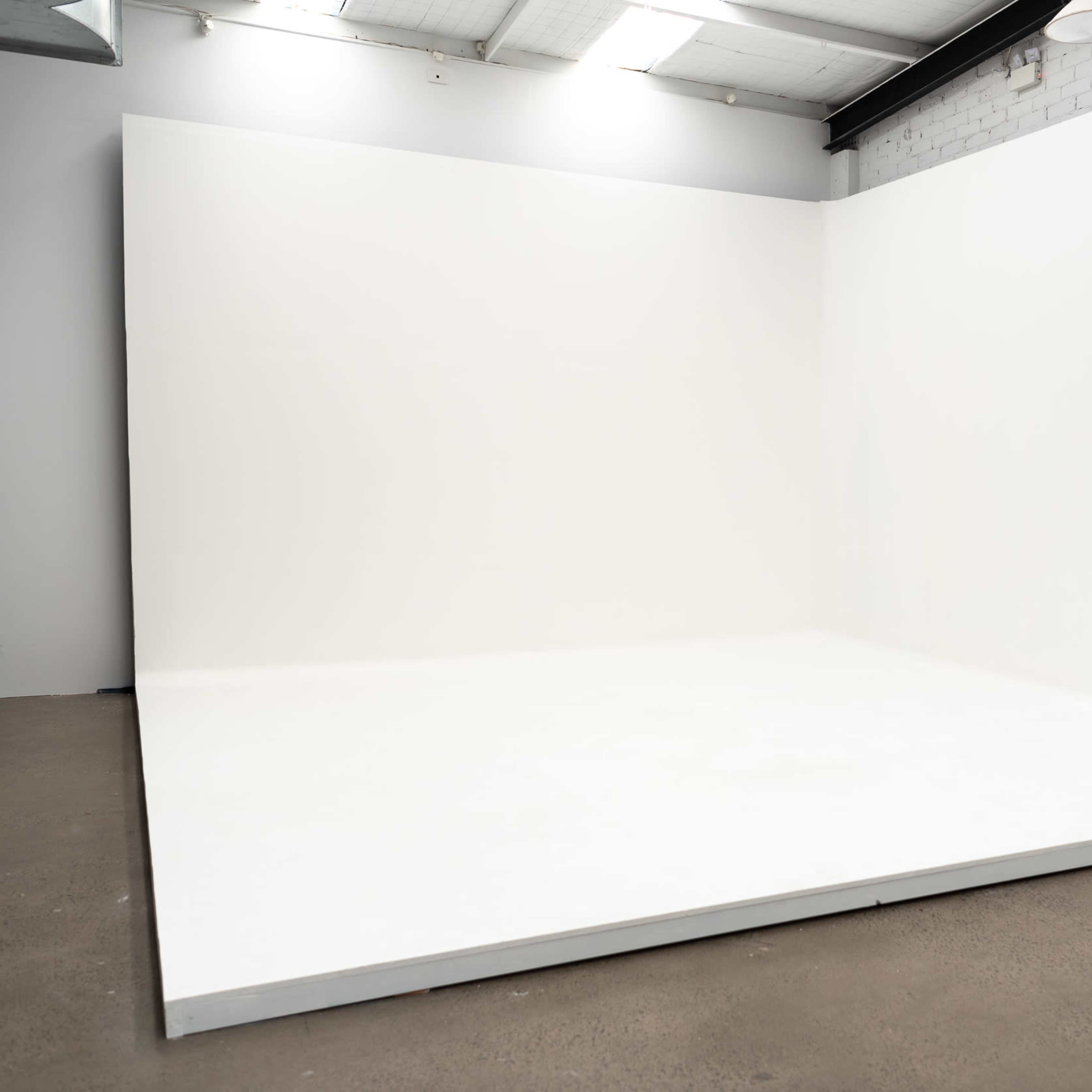 A large empty white room with a smooth floor and an uncrowded backdrop.