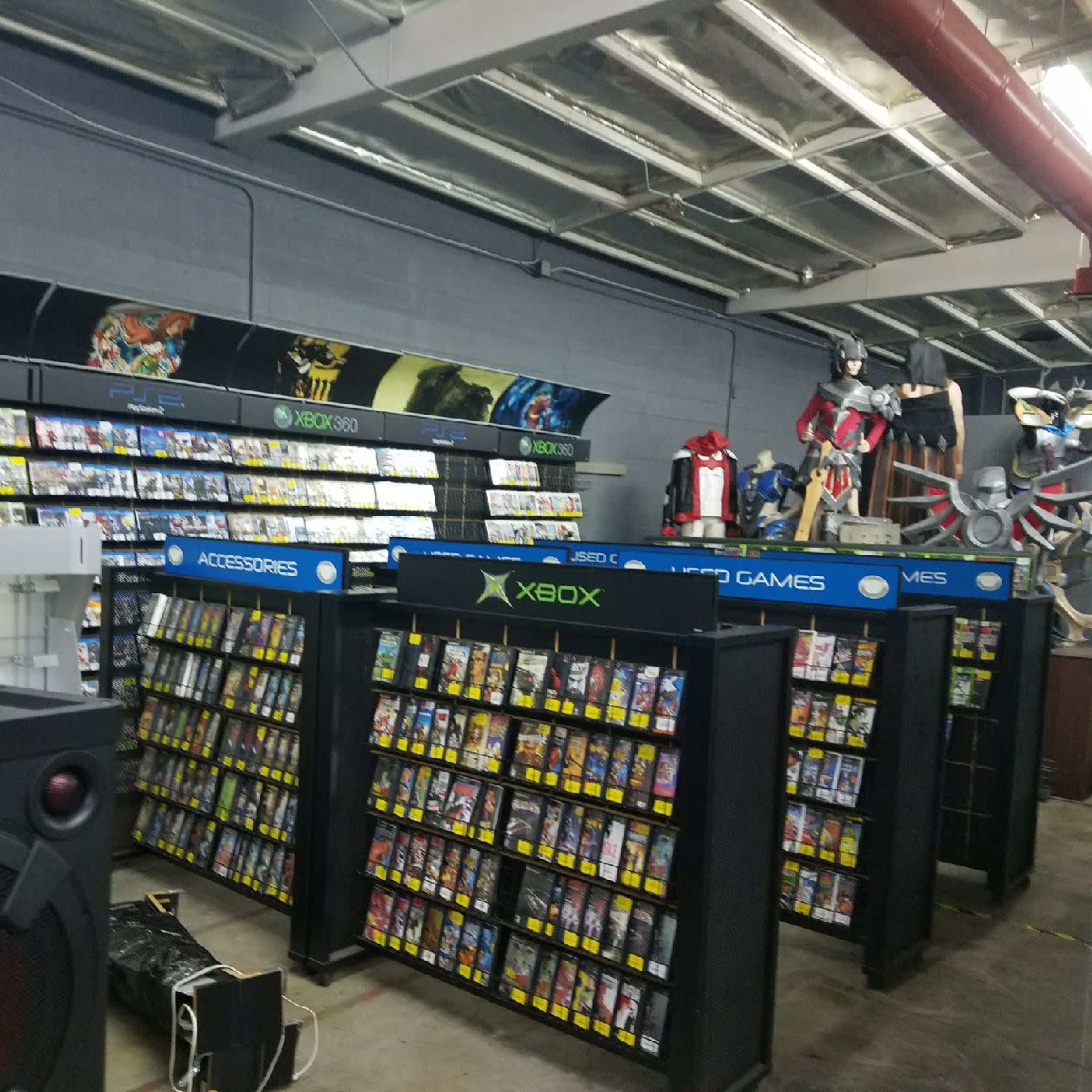 A retail store aisle filled with shelves of video games and consoles, featuring organized displays and gaming accessories.