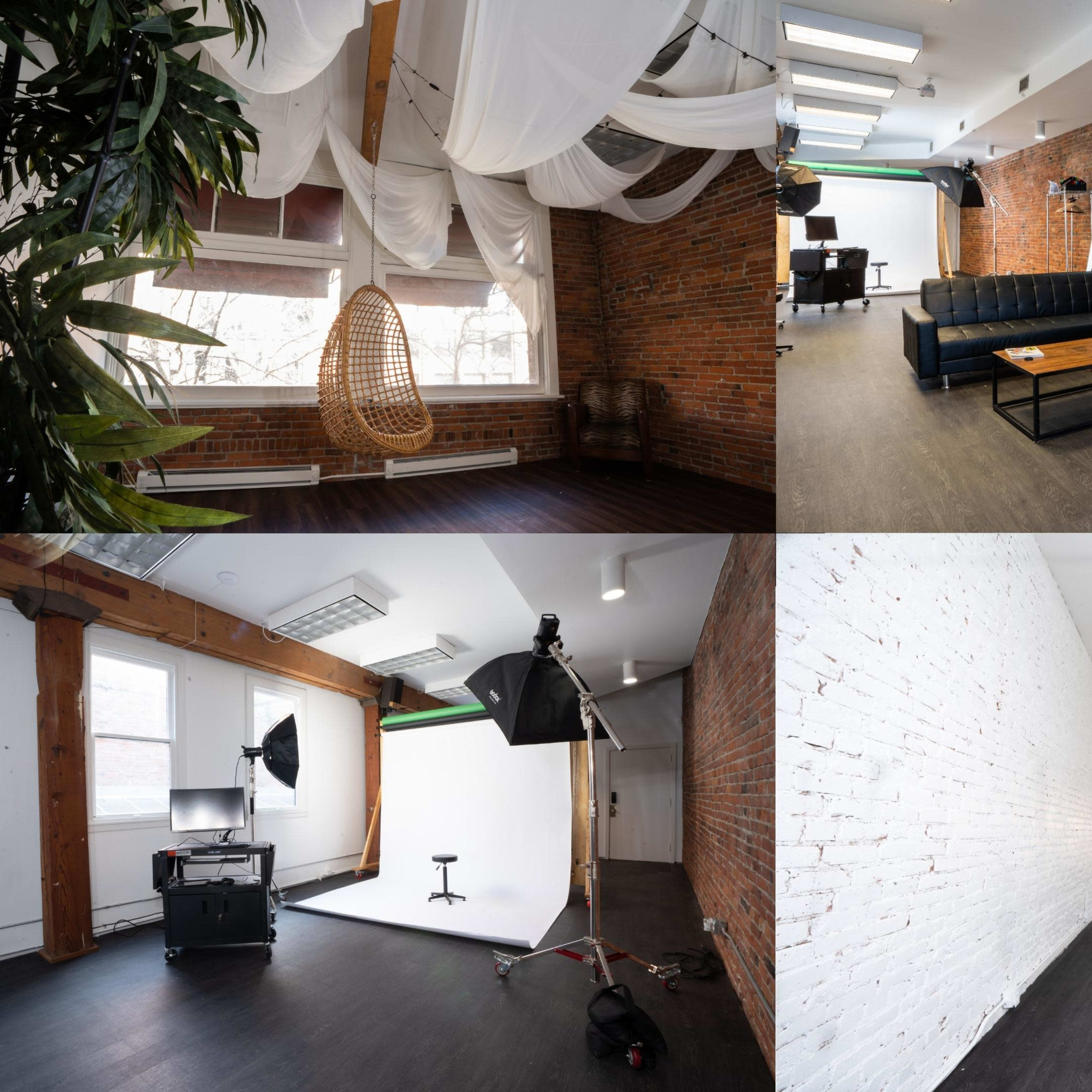 A modern studio space featuring various areas, including a seating area, a photographic backdrop, and a vintage phone booth, all within a brick-walled environment.