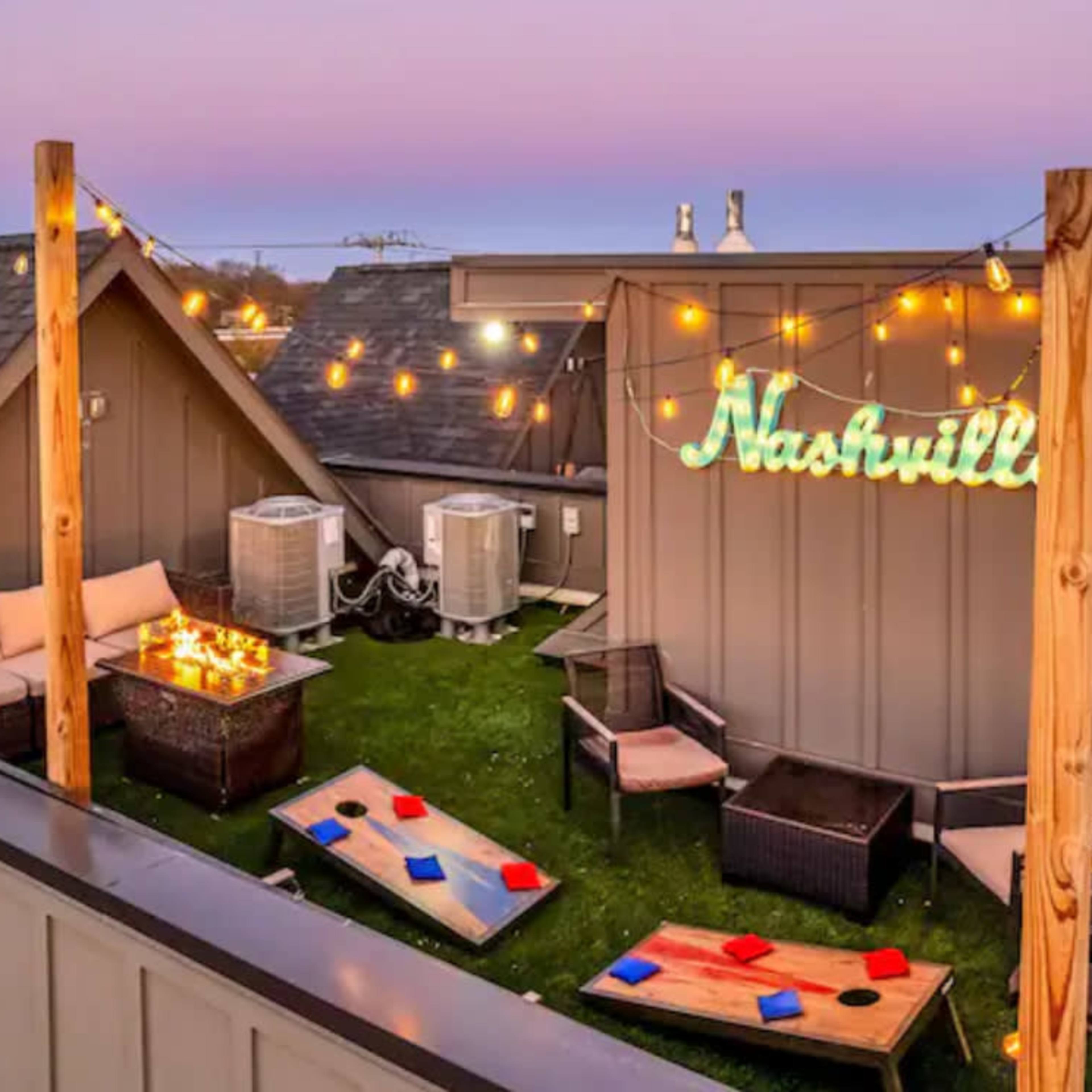 The rooftop terrace features string lights, seating areas, and a neon sign that reads "Nashville."