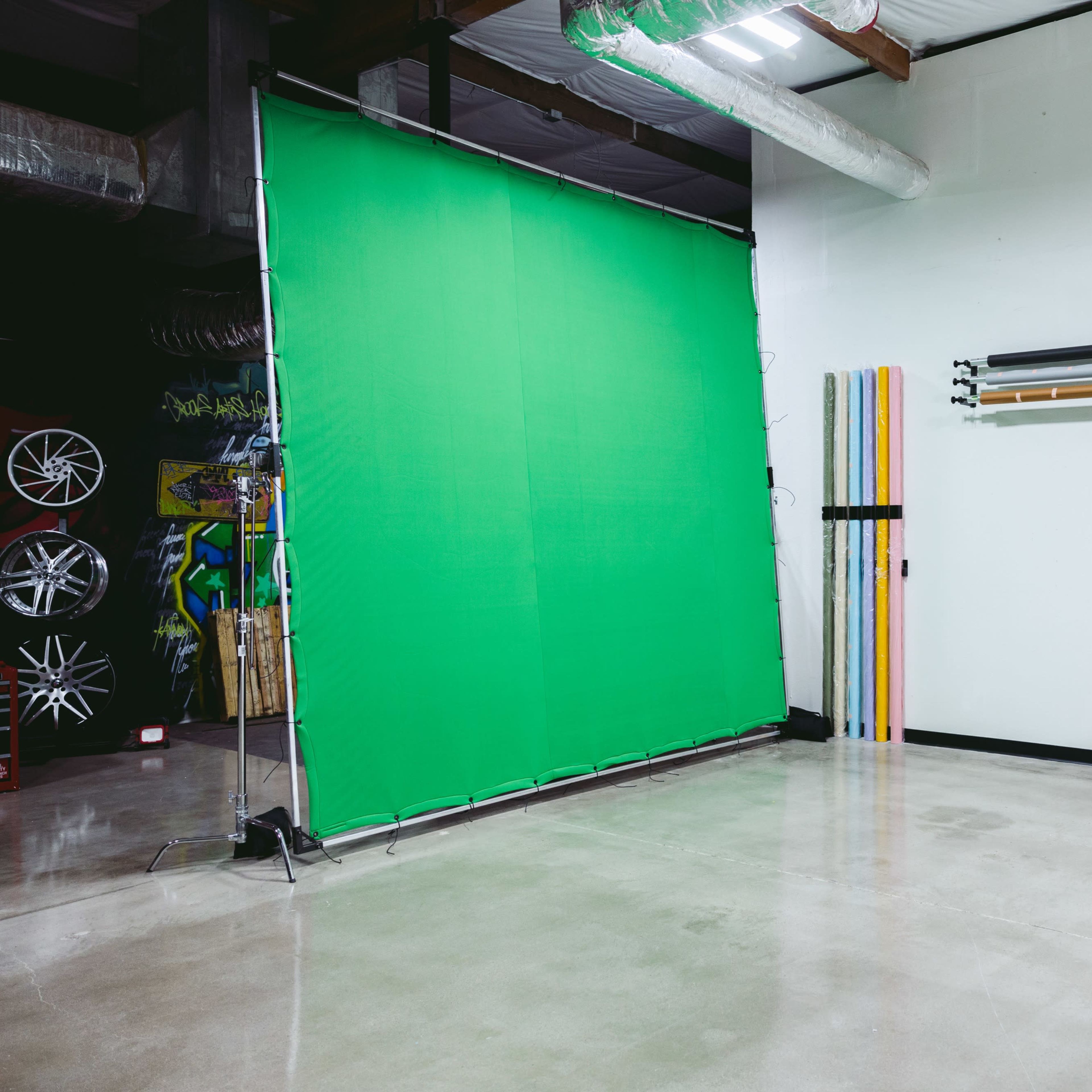 Four distinct scenes: a red-lit studio, a dimly lit area with shelves and smoke, a vintage diner with checkered flooring, and an office workspace filled with older technology.