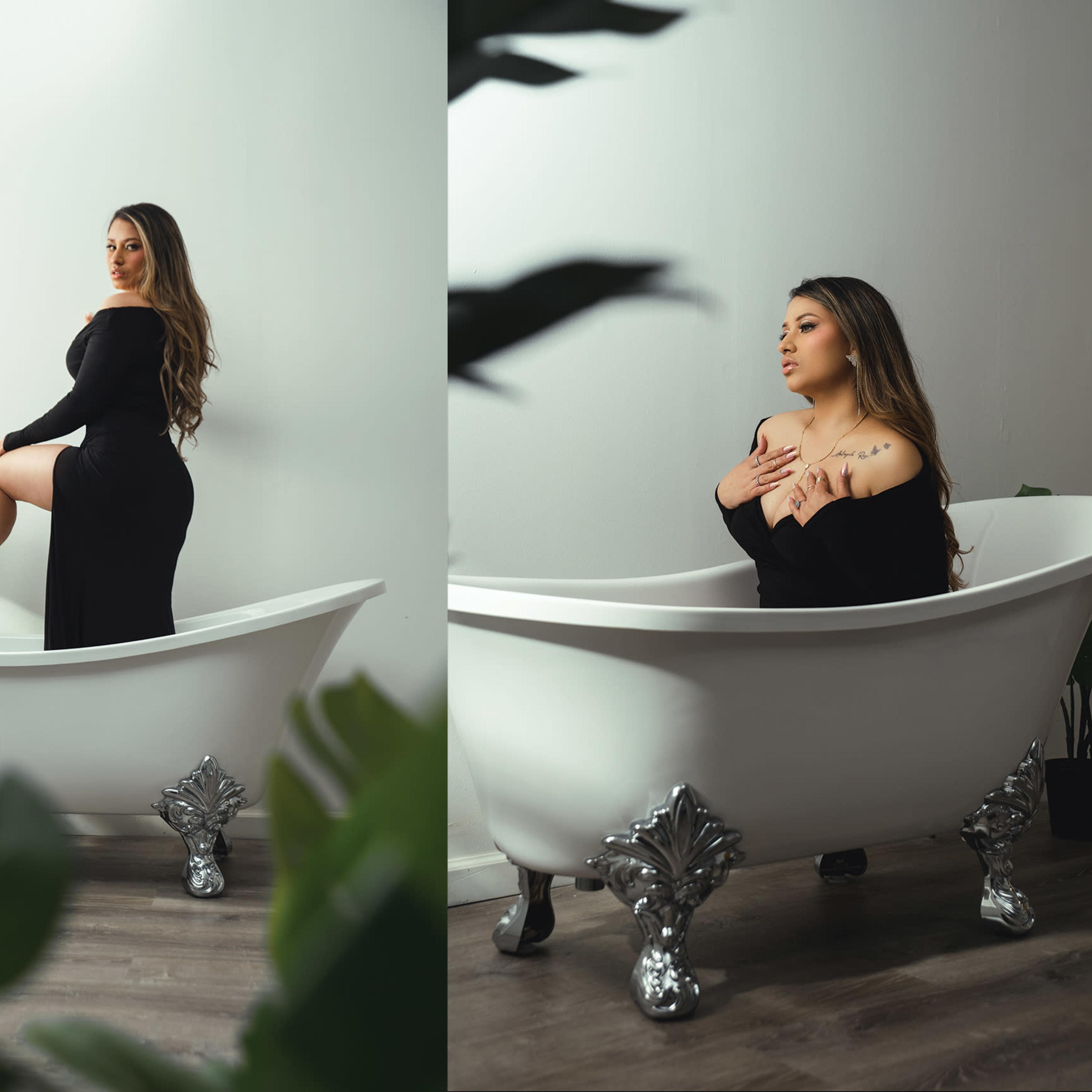 A woman poses in a black dress while standing in a vintage bathtub surrounded by greenery.