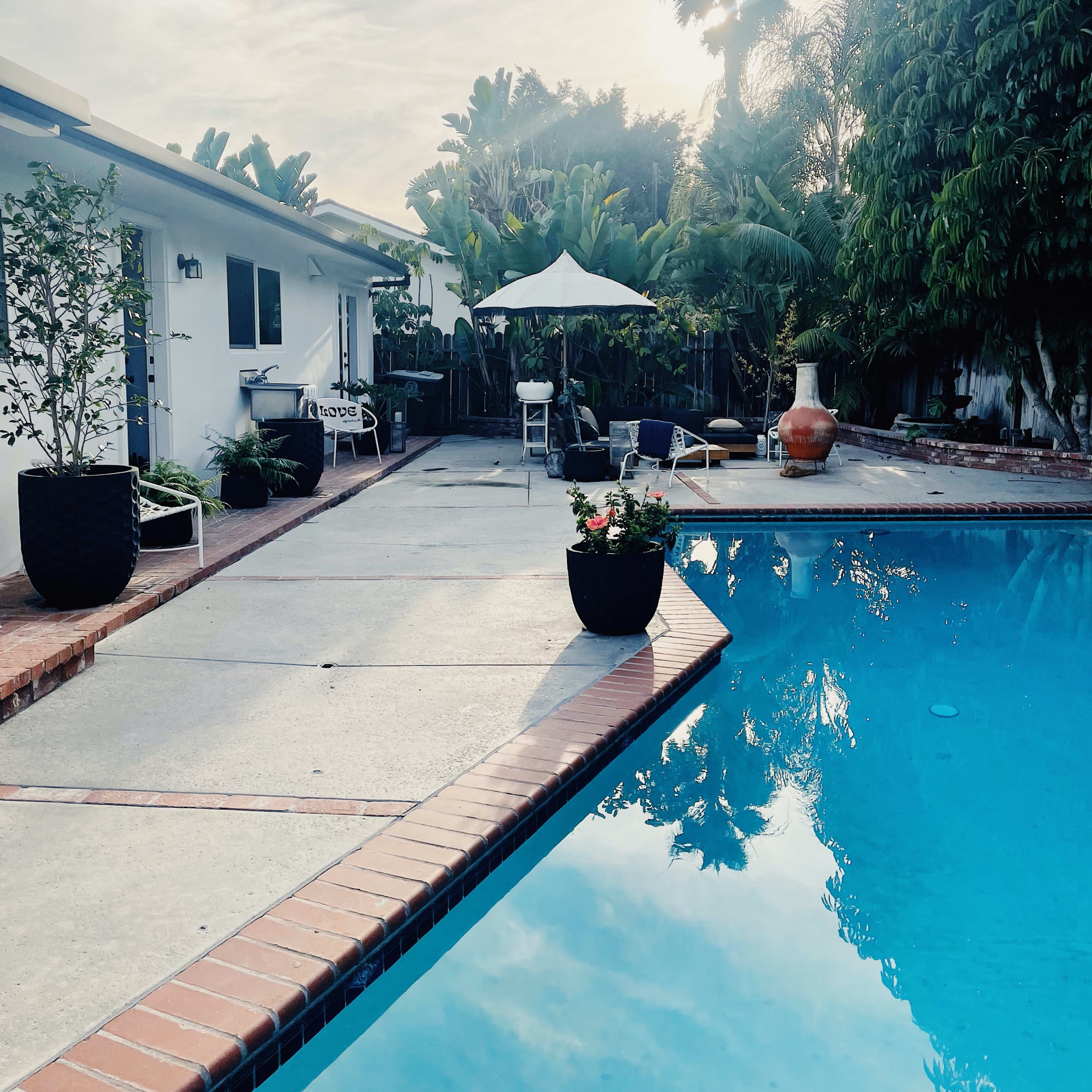 Single Story California Coastal Ranch Style Home with Open Floorpan, Lush Backyard Landscaping, and MCM Pool Image in East Side Costa Mesa, Newport Beach, CA