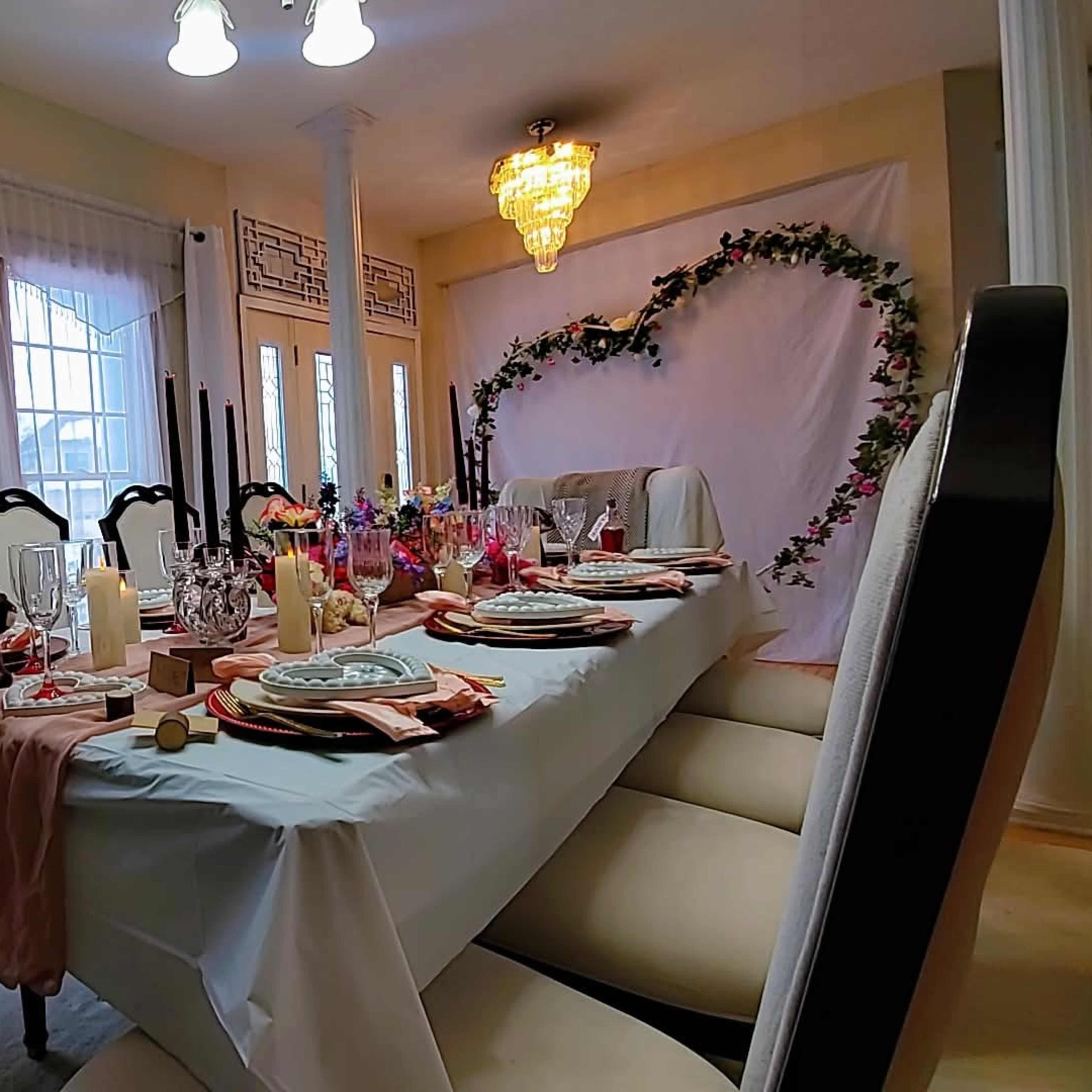Love's Enchanted Oasis." This romantic dinner table is a masterfully crafted haven, where love and magic entwine. The soft glow of candles, the gentle dance of flowers, and the warm, inviting ambiance all converge to create an intimate and enchanting atmosphere, perfect for a dreamy Valentine's Day celebration. Image in LaSalle, Buffalo, NY