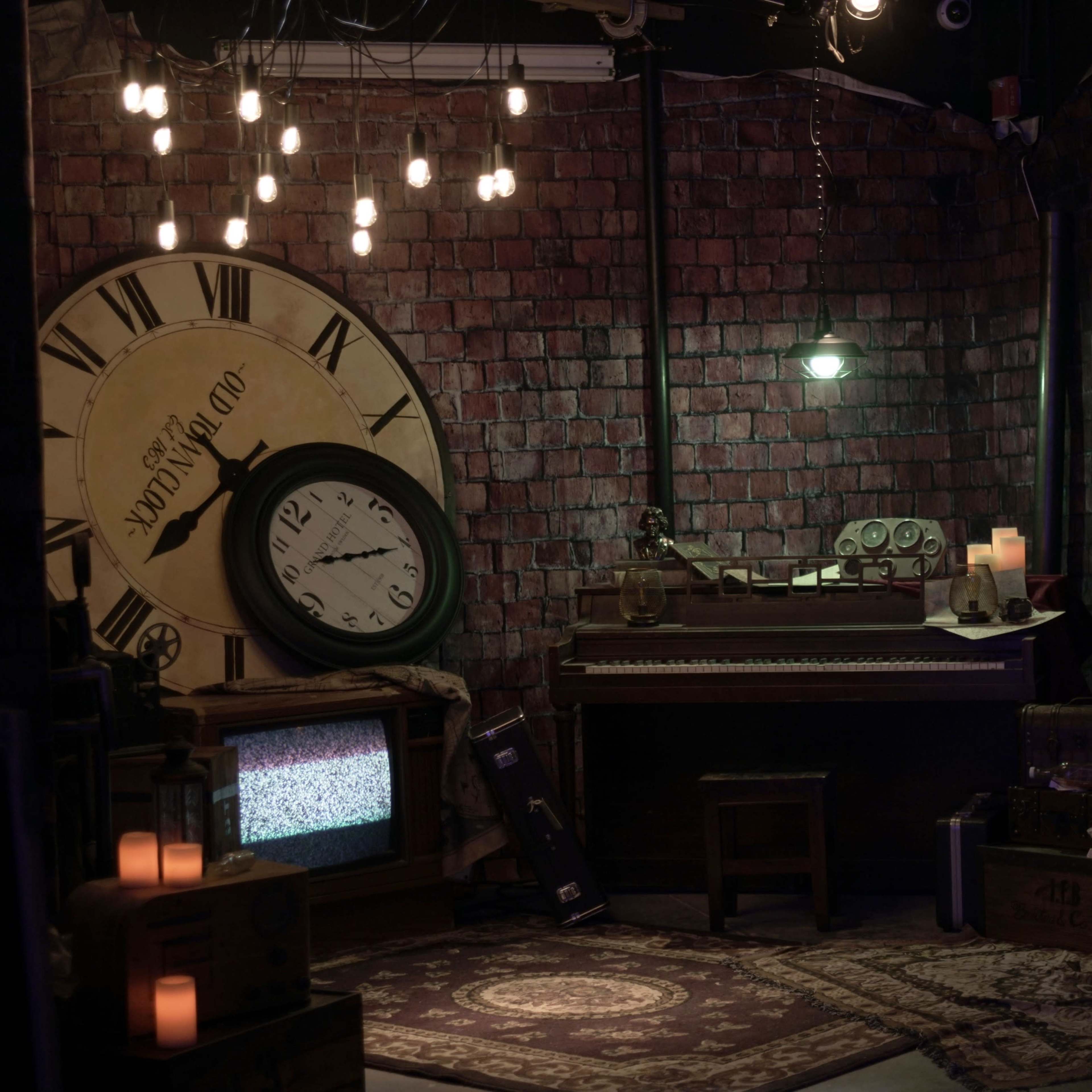 The scene features a dimly lit room with brick walls, a large clock, a piano, vintage furniture, and various decorative items casting a nostalgic atmosphere.