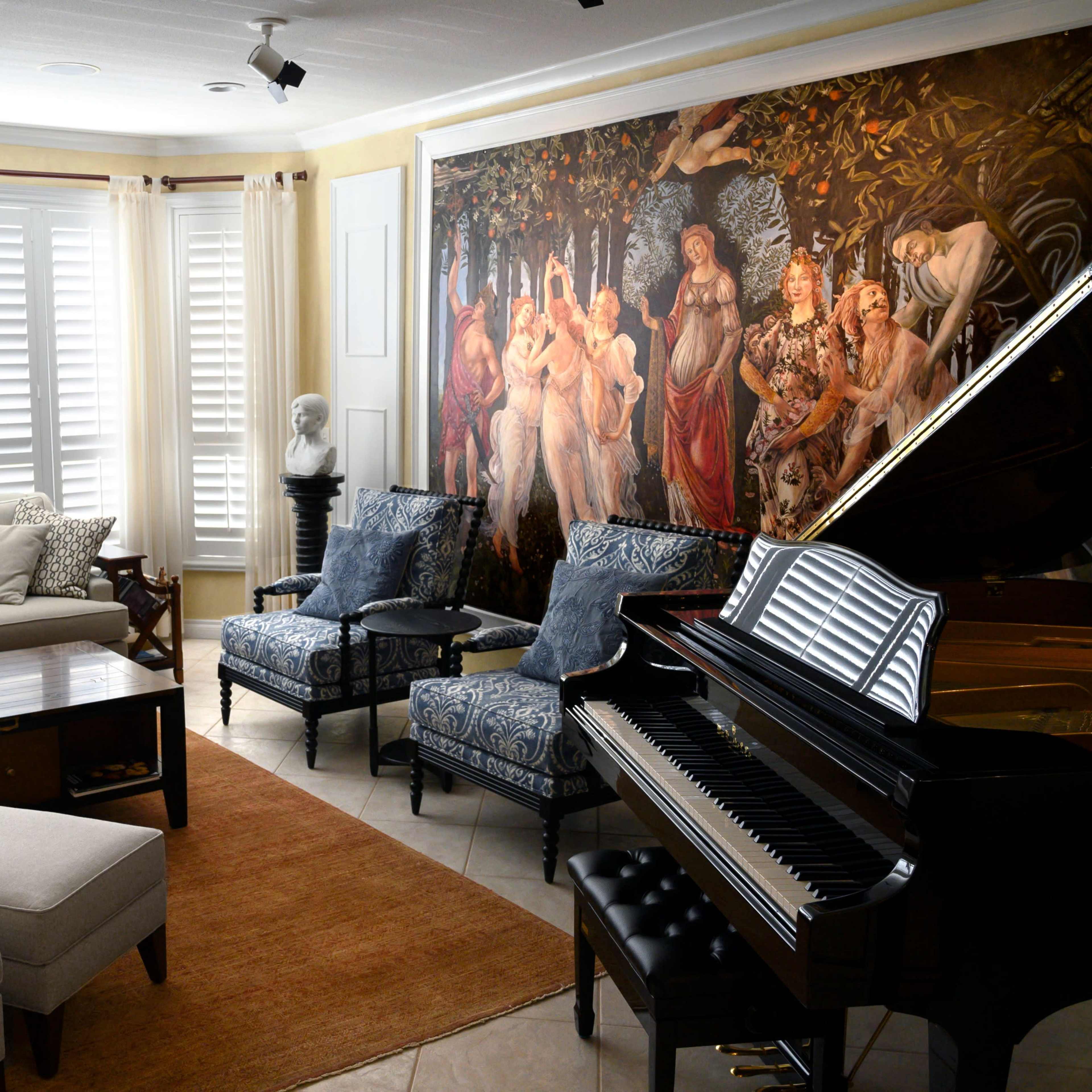 The living room features a grand piano, a large couch, two patterned chairs, a coffee table, and a mural depicting a group of figures on one wall.