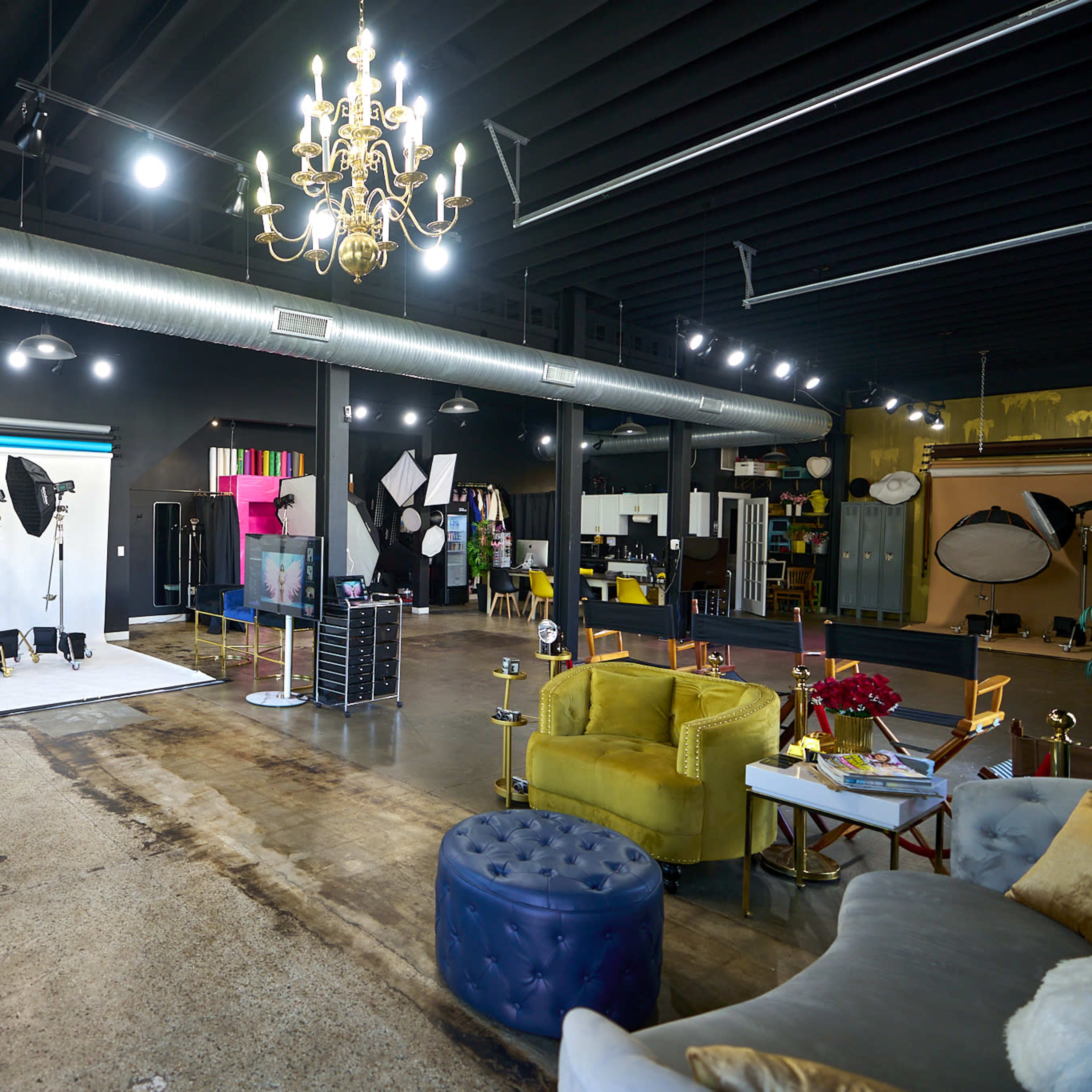 A large studio space with various photography equipment, seating areas, and decorative elements.