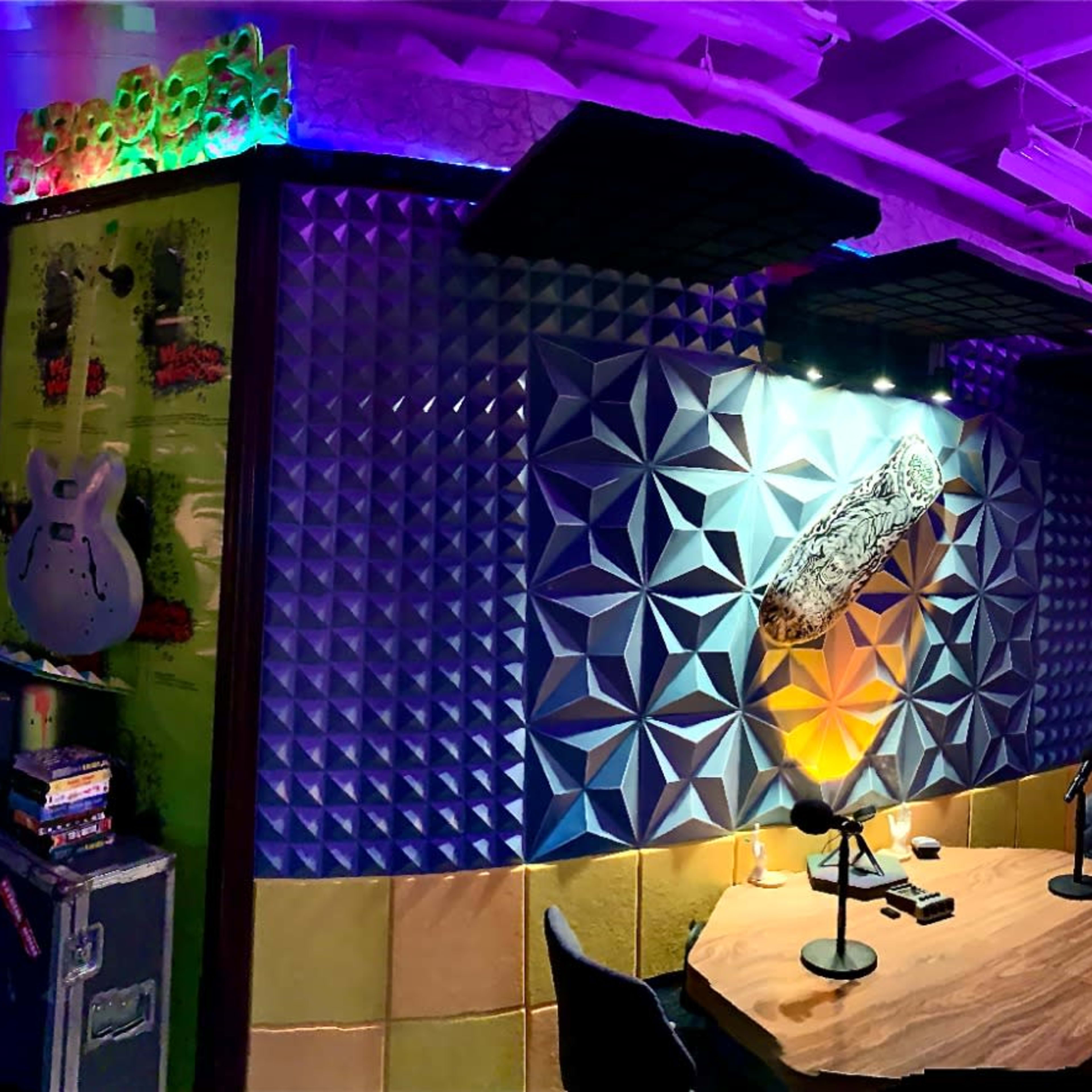 A colorful music studio filled with various soundproofing panels, instruments, and ambient lighting.