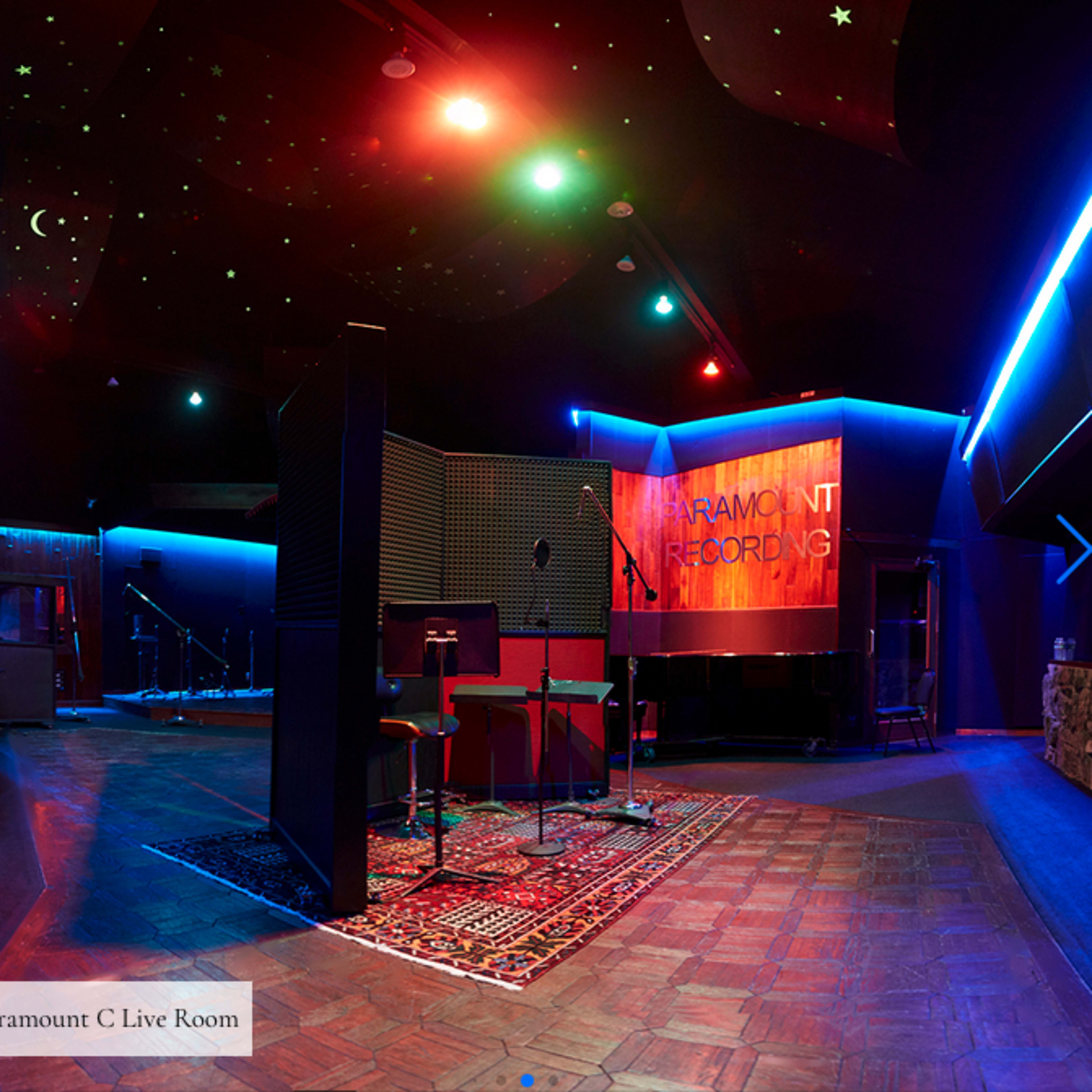 A recording studio live room with a starry ceiling, colorful lighting, and equipment set up for recording.