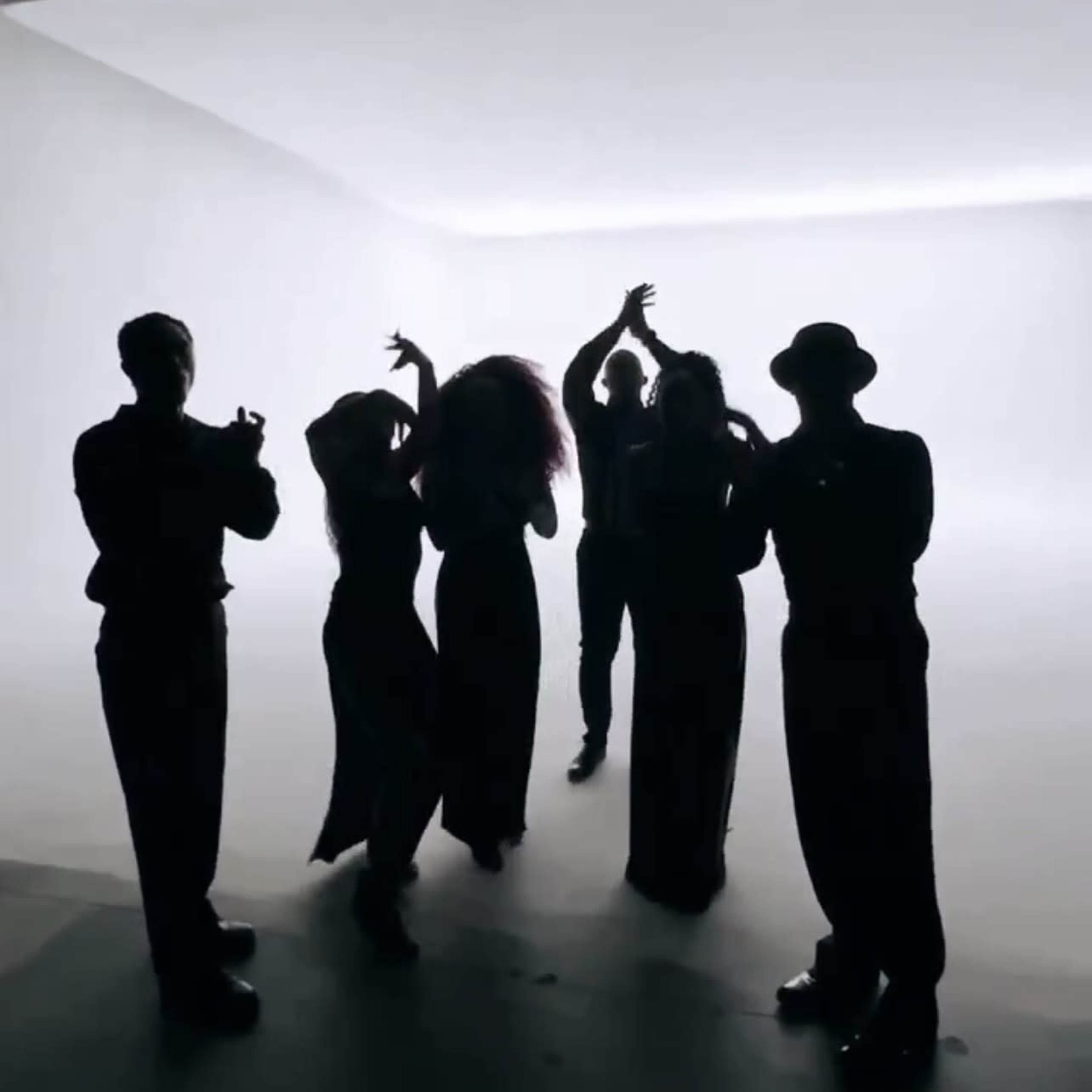 Silhouettes of six people in formal attire pose against a brightly lit background.