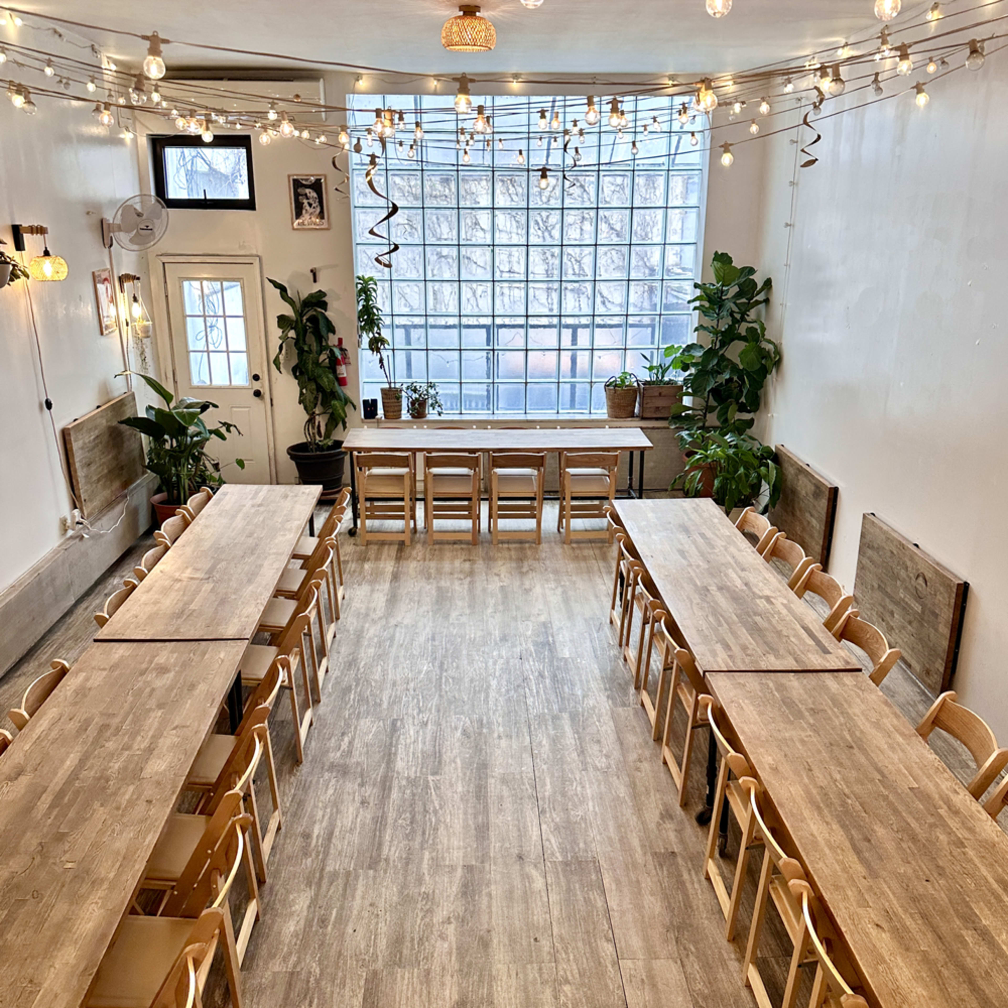 Sunlit Williamsburg Space with Wooden Furniture & Lush Greenery Image in Williamsburg, Brooklyn, NY