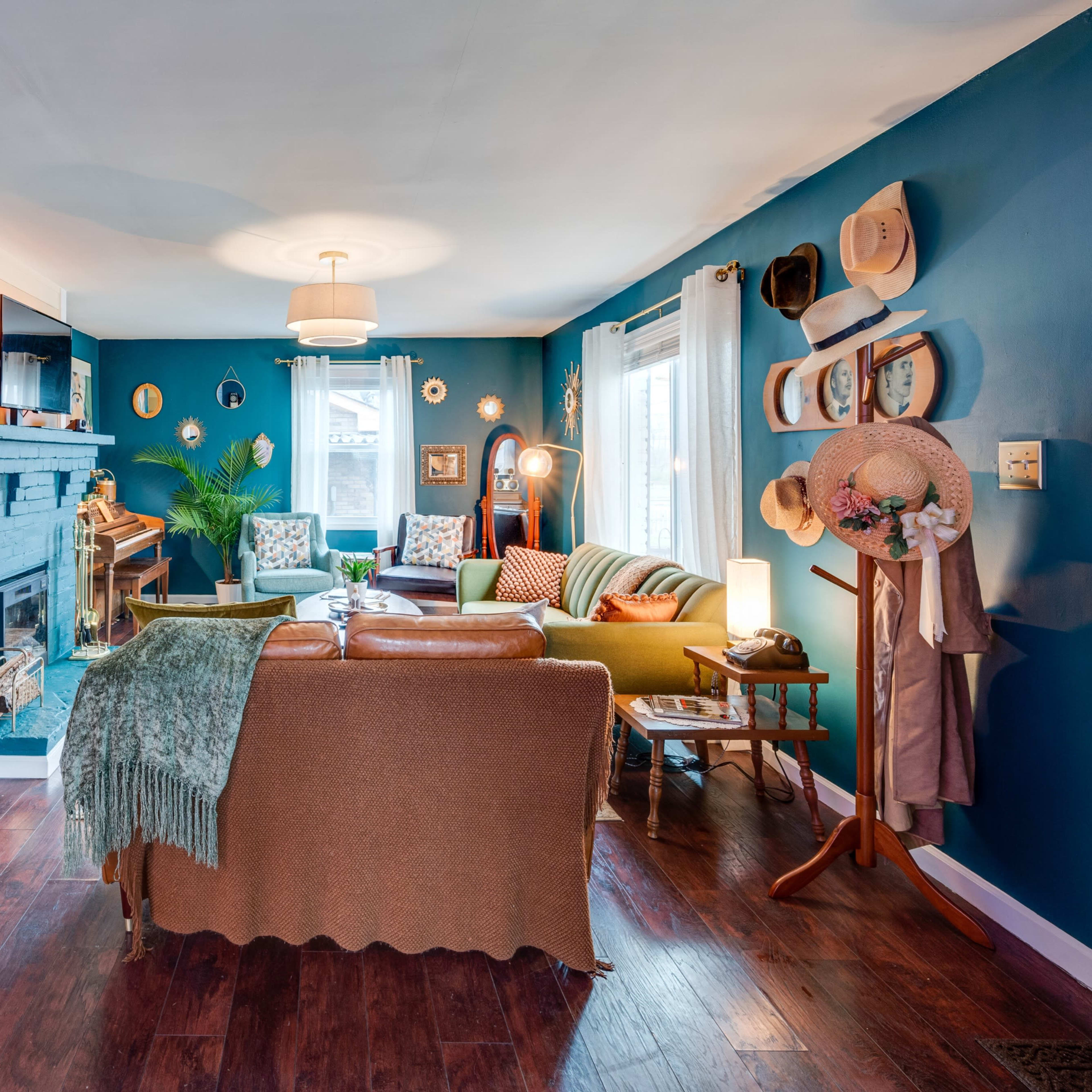 A brightly colored living room features a mix of seating, a fireplace, and decorative elements on the walls.