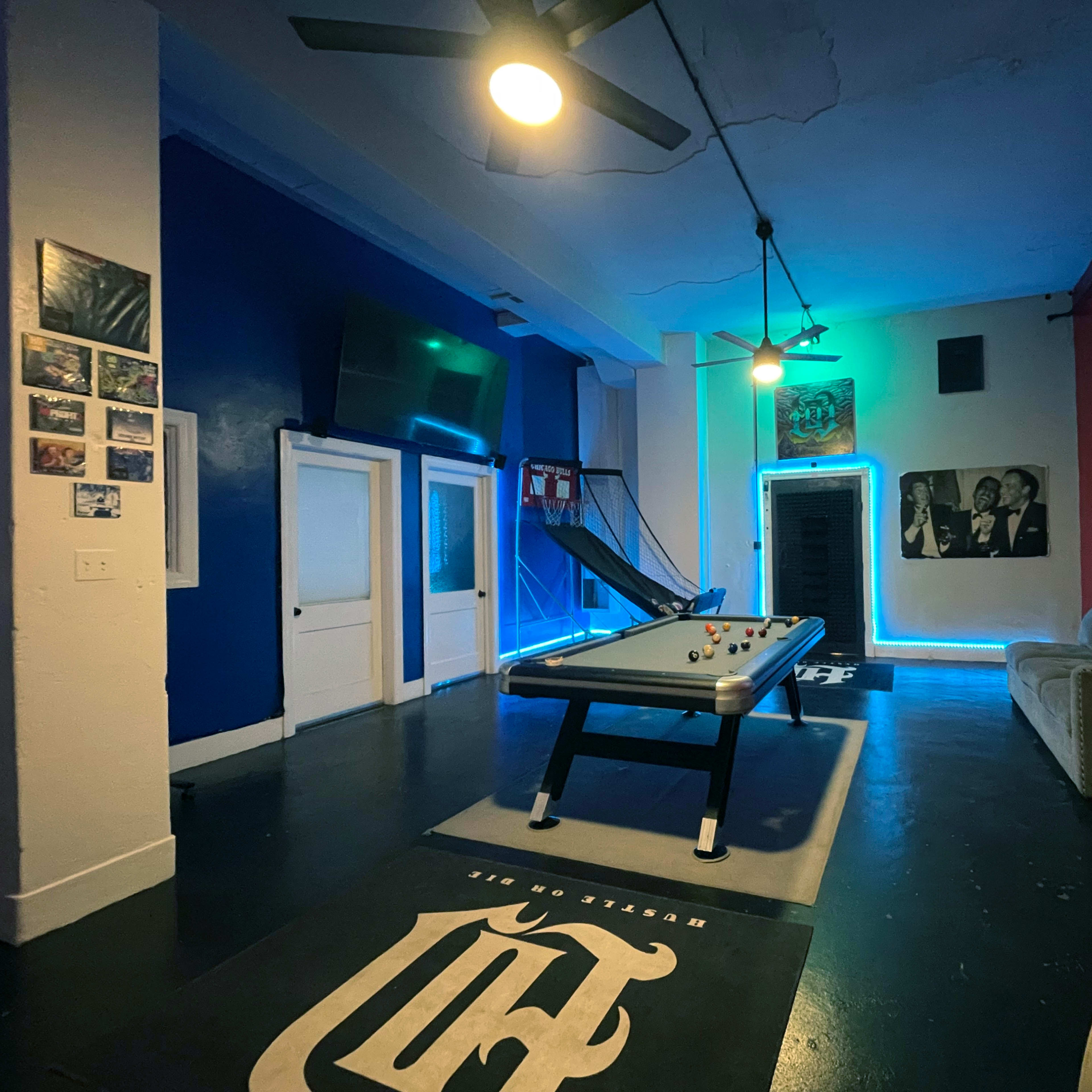 A recreational room featuring a pool table, a Chicago flag on the wall, and modern lighting accents.