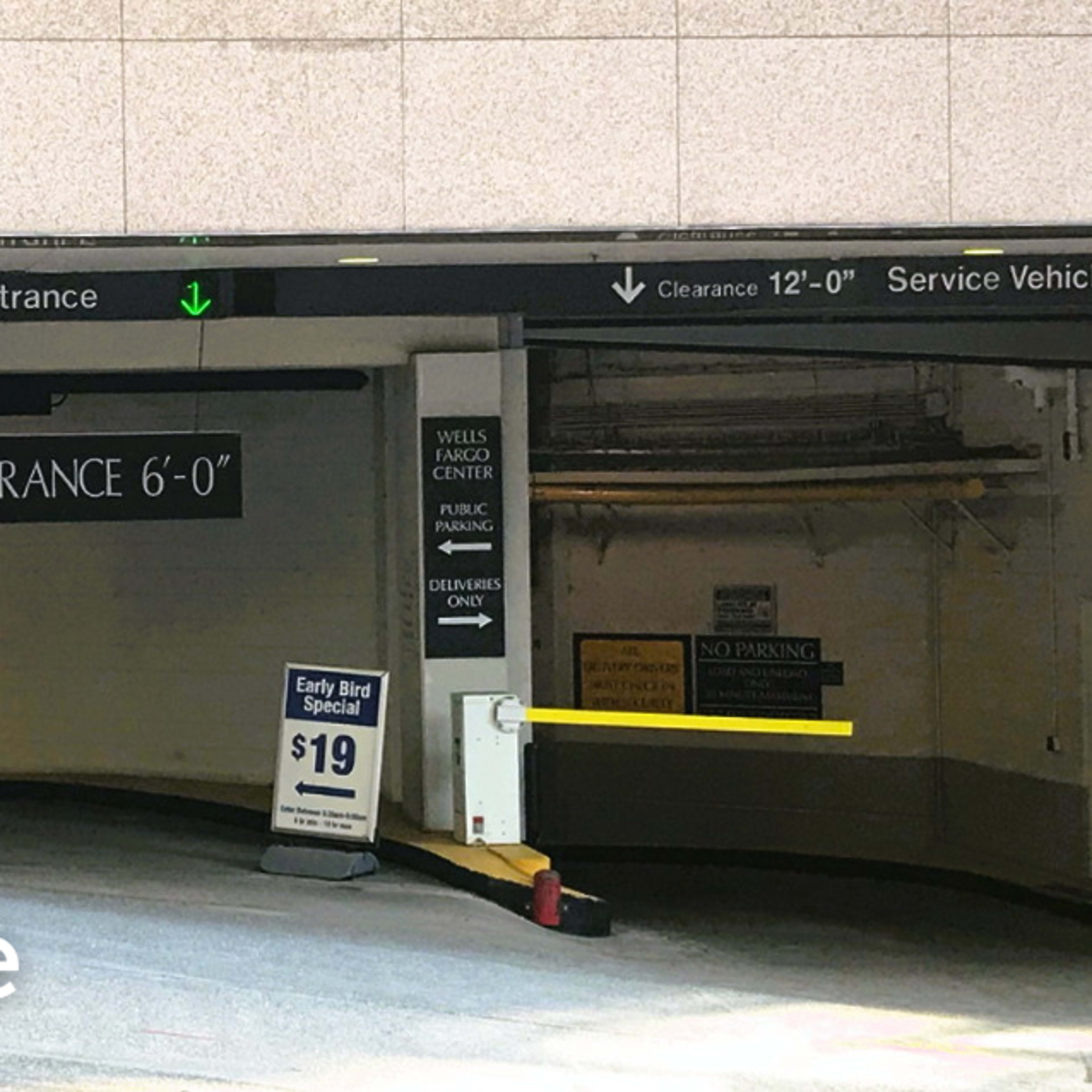 The entrance to a parking garage with clearance signs indicating height limits.