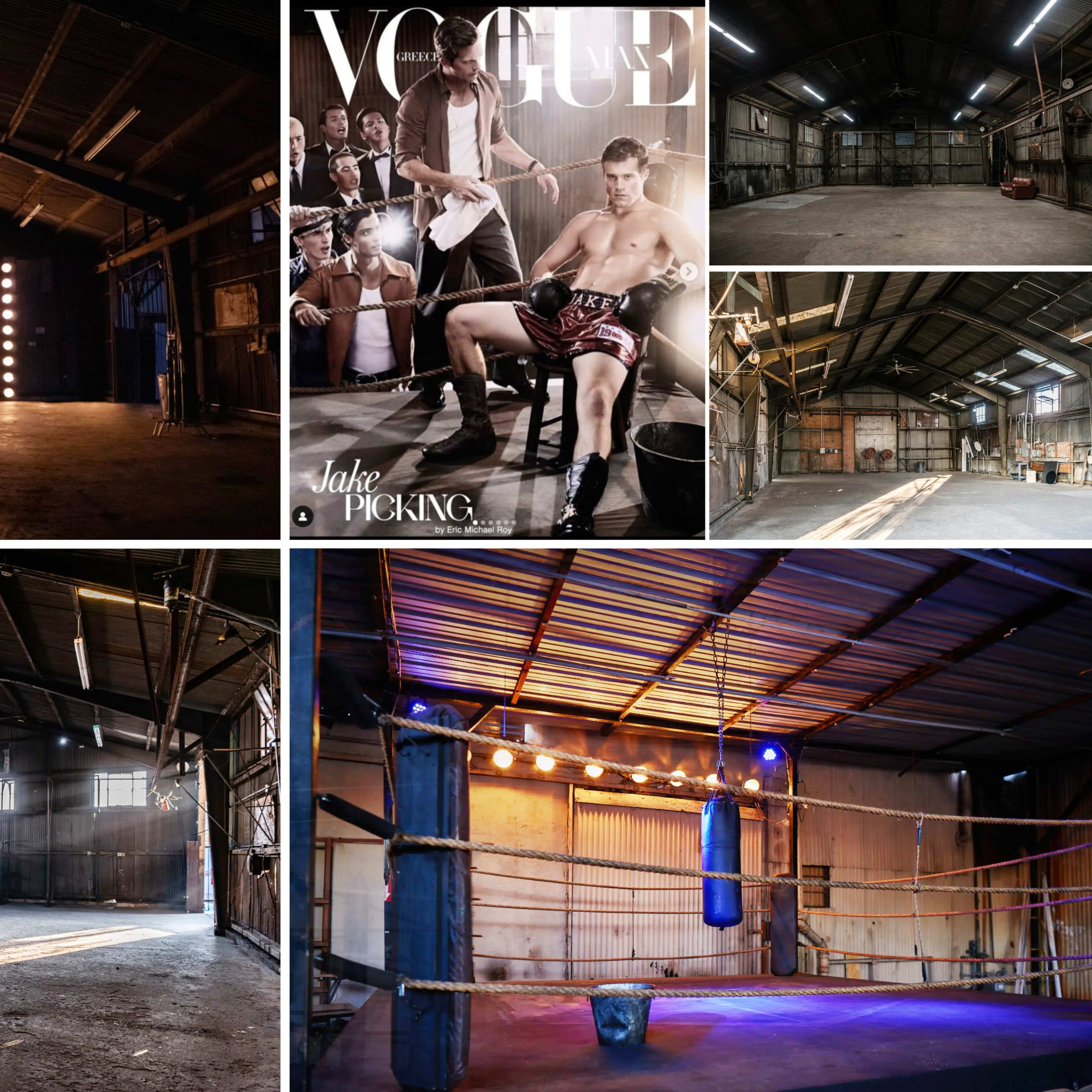 A dimly lit warehouse space with exposed beams, a boxing ring, studio lighting, and a Vogue magazine cover featuring a male model in a seated pose.