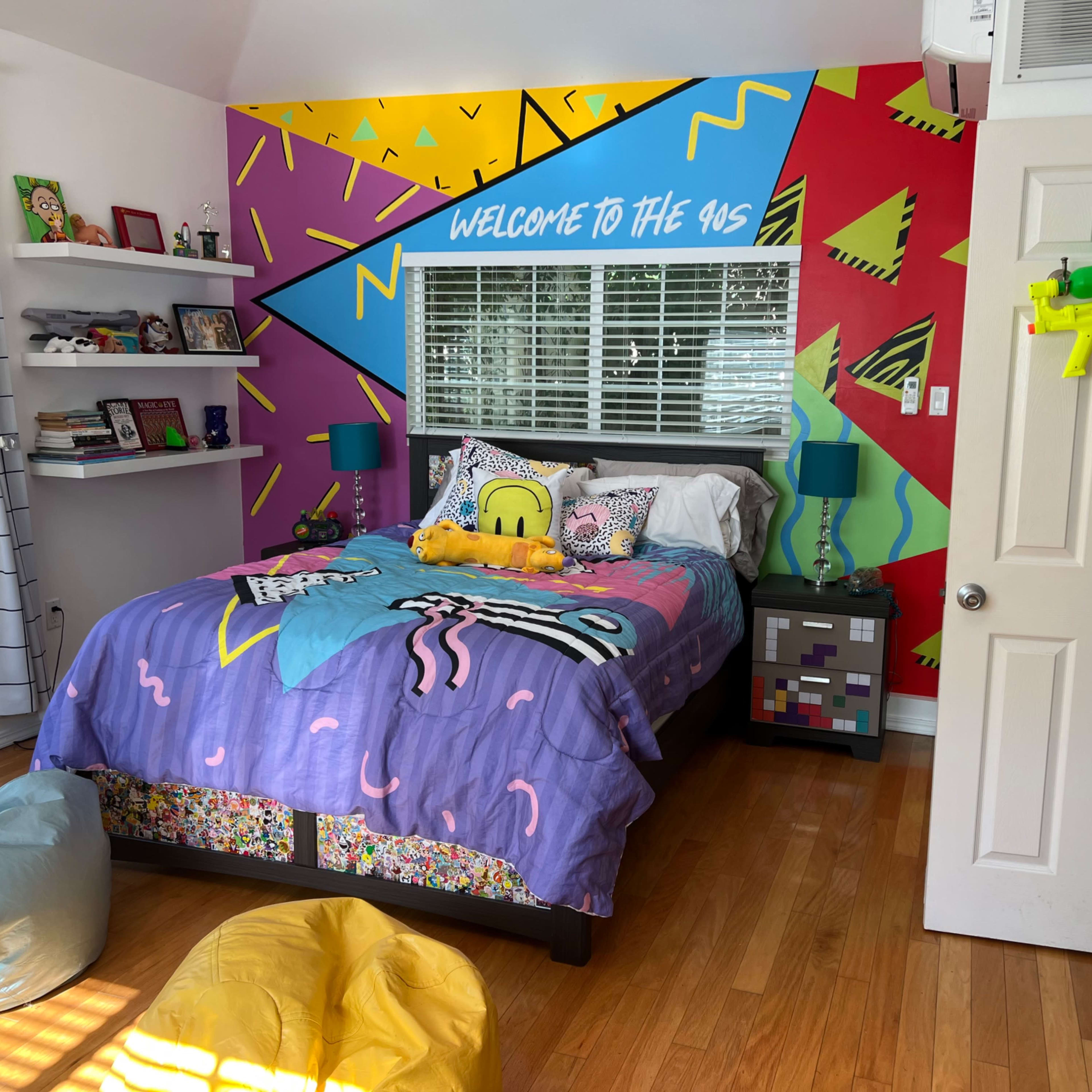 A brightly decorated bedroom featuring a patterned bedspread, a colorful mural on the wall, and various playful accessories.