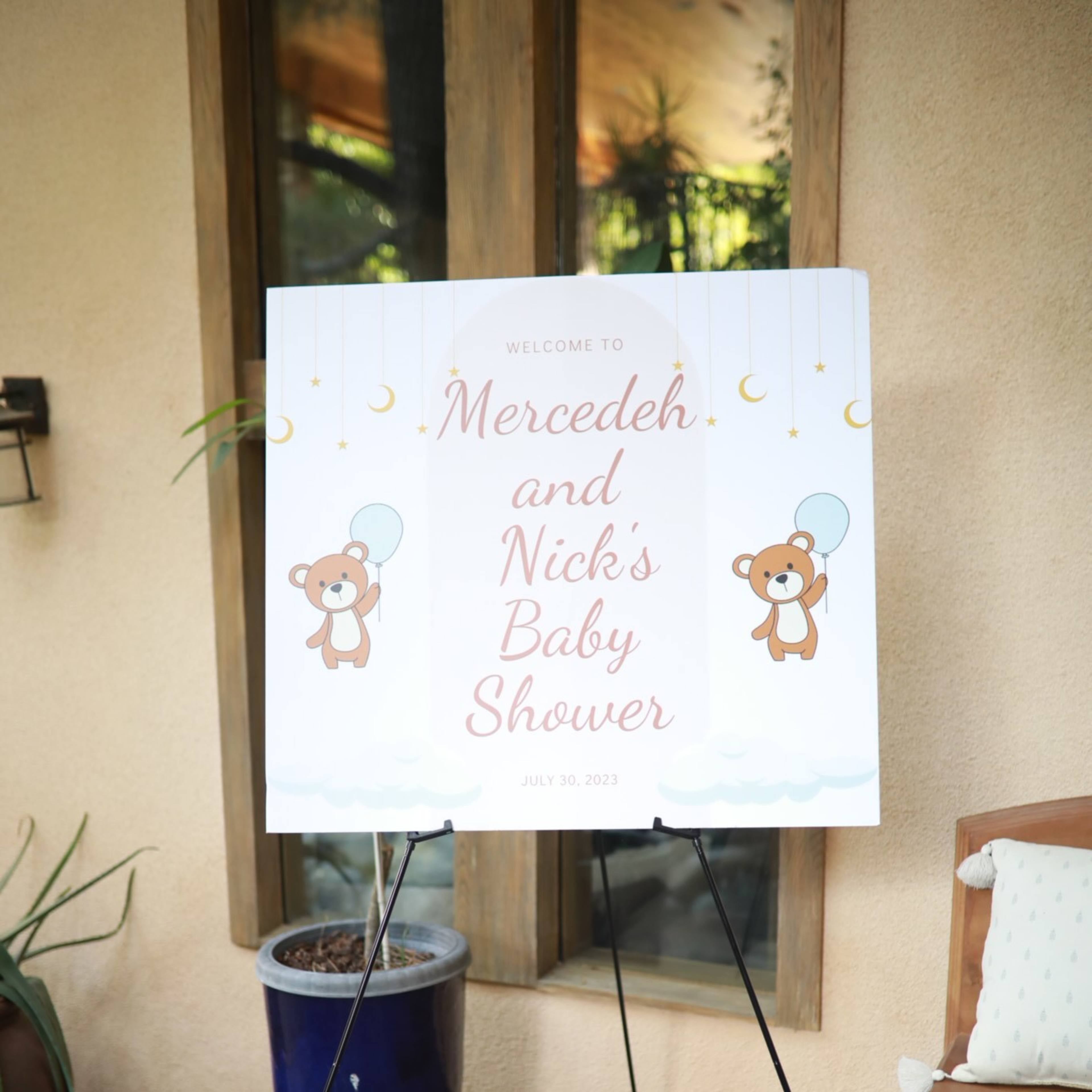 A sign welcoming guests to Mercedes and Nick's baby shower is displayed outside, featuring teddy bear graphics and the event date of July 30, 2022.