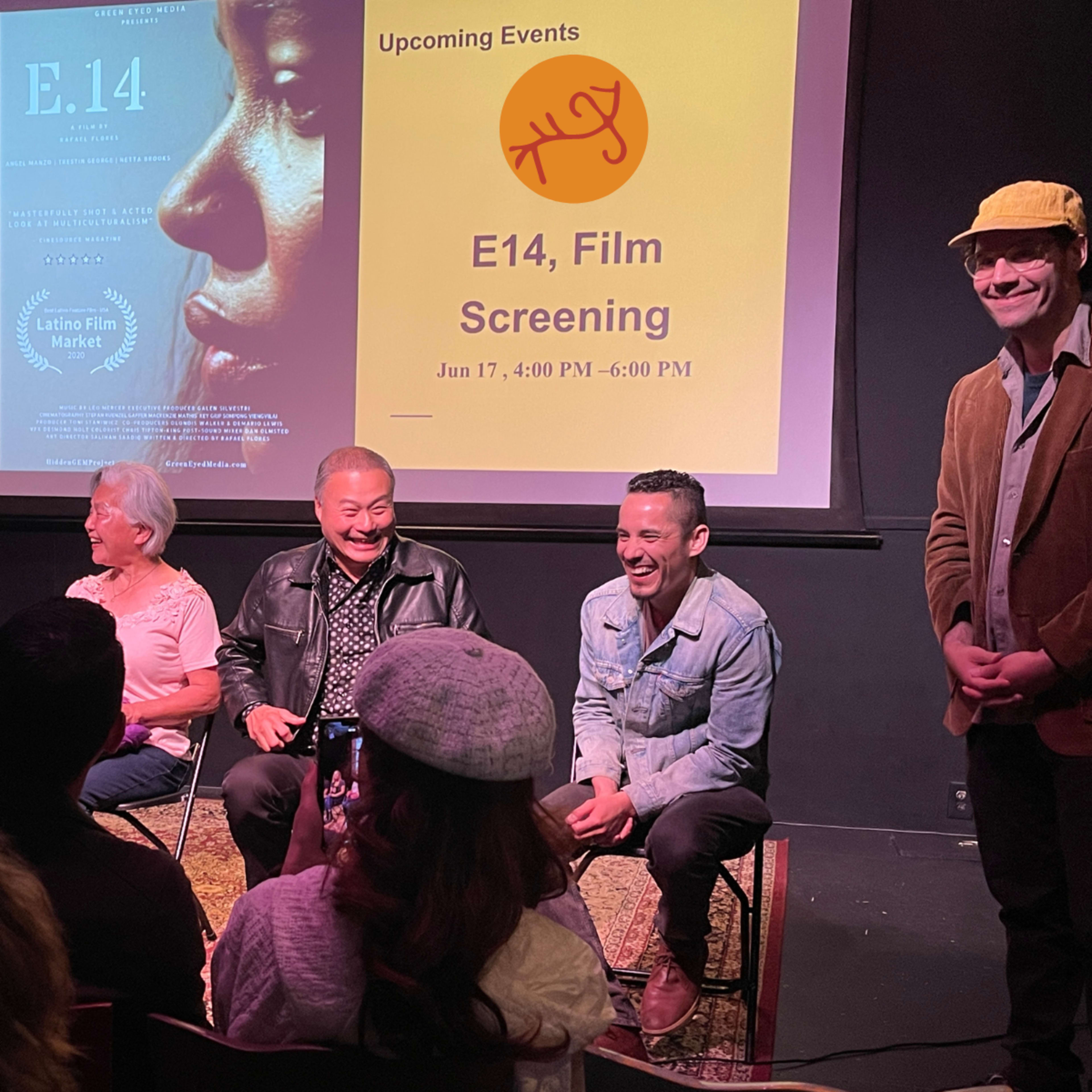 A panel of five individuals sits on stage during a film screening event, with a poster and event details displayed in the background.