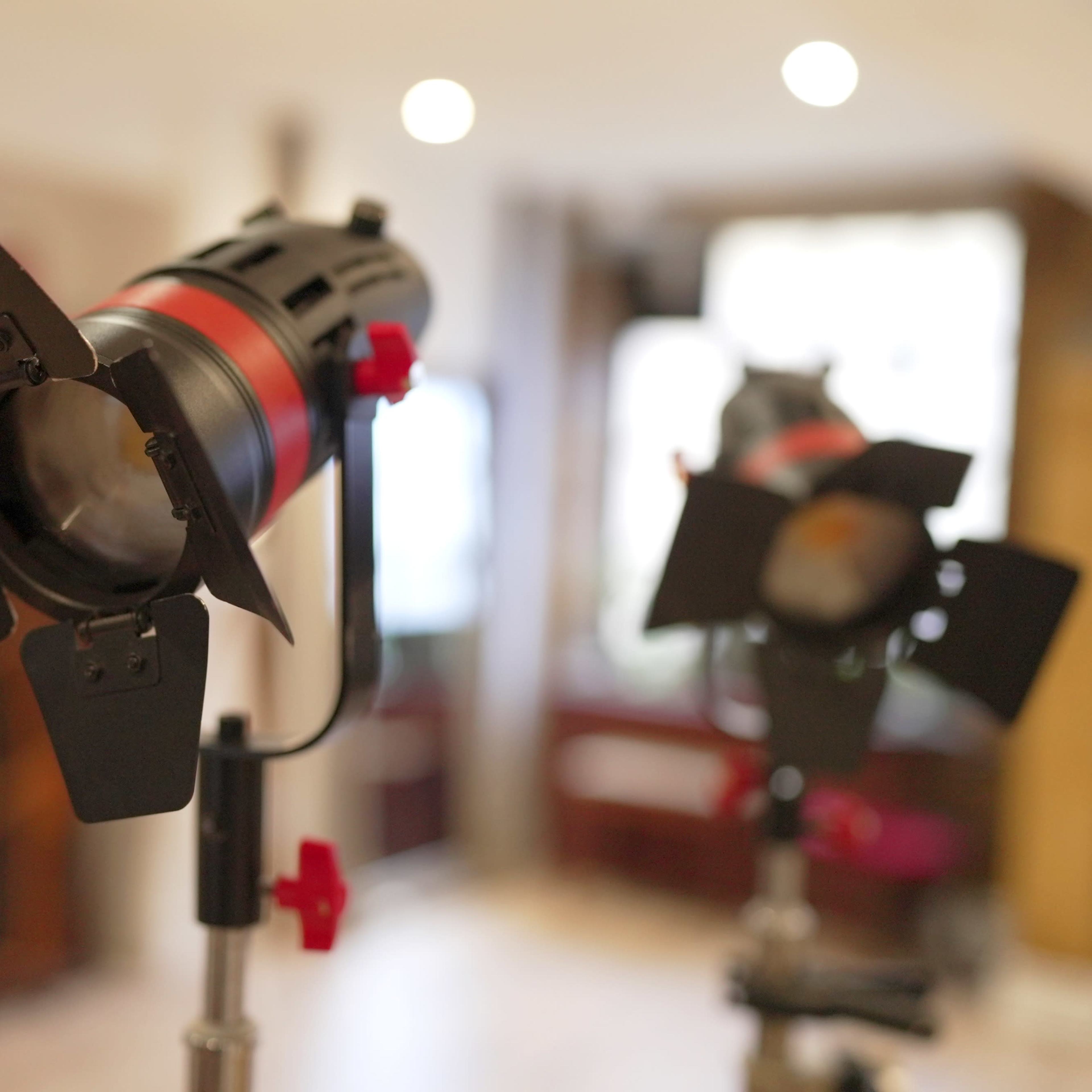 Two photography light fixtures with snoots set up in an indoor setting.