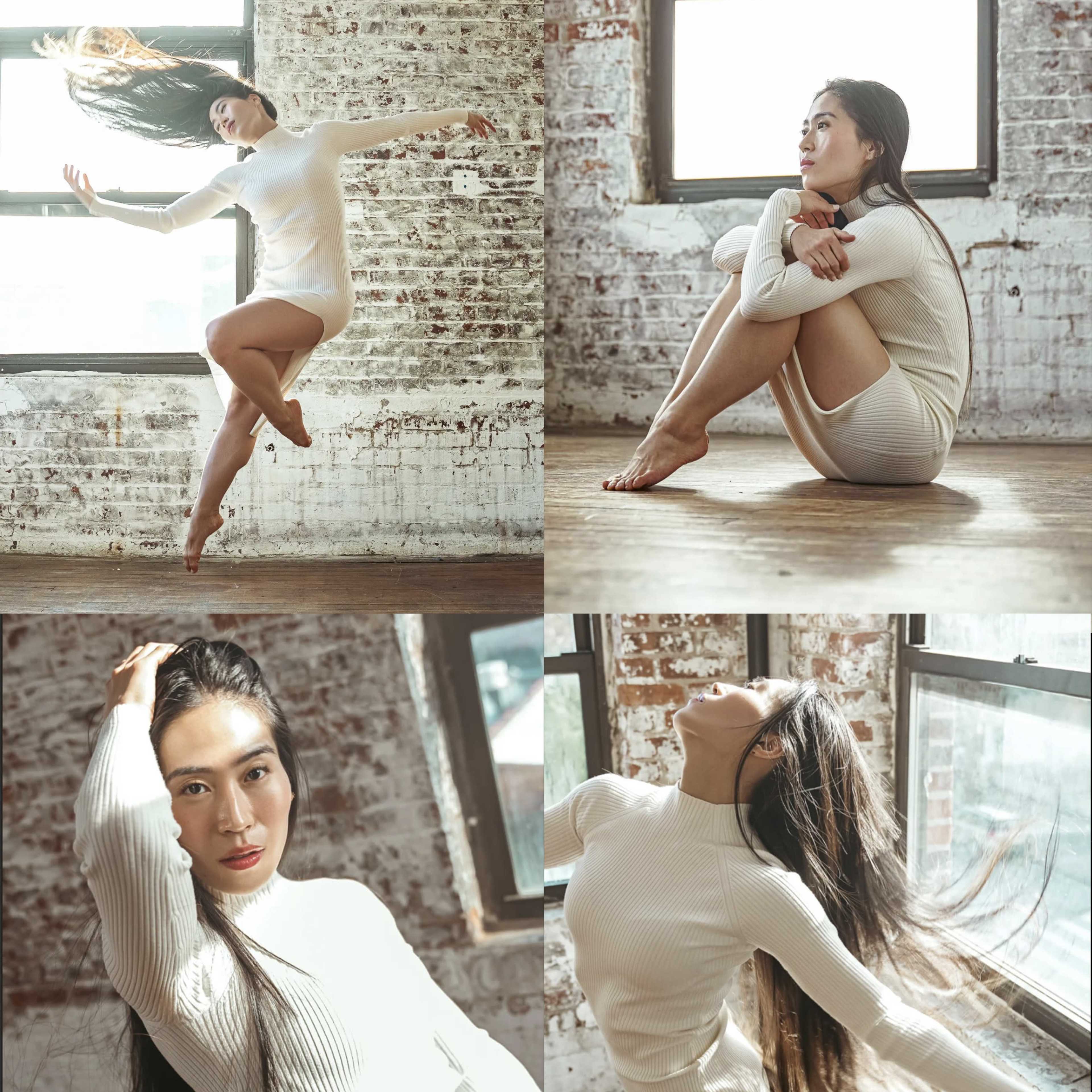 A woman in a white outfit posing dynamically in a sunlit, rustic interior with exposed brick walls and large windows.