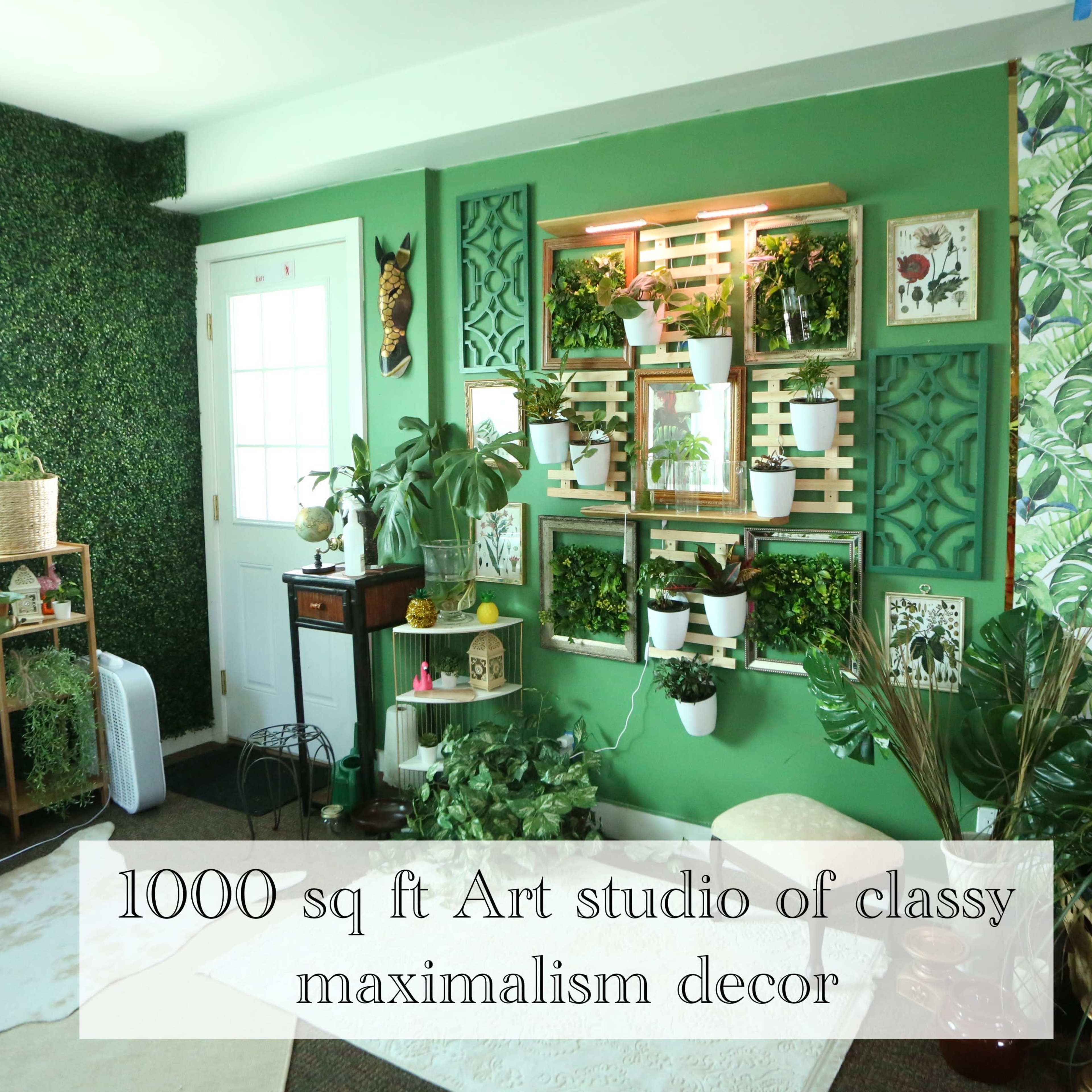 A 1000 sq ft art studio featuring green walls adorned with plants and decorative shelving.