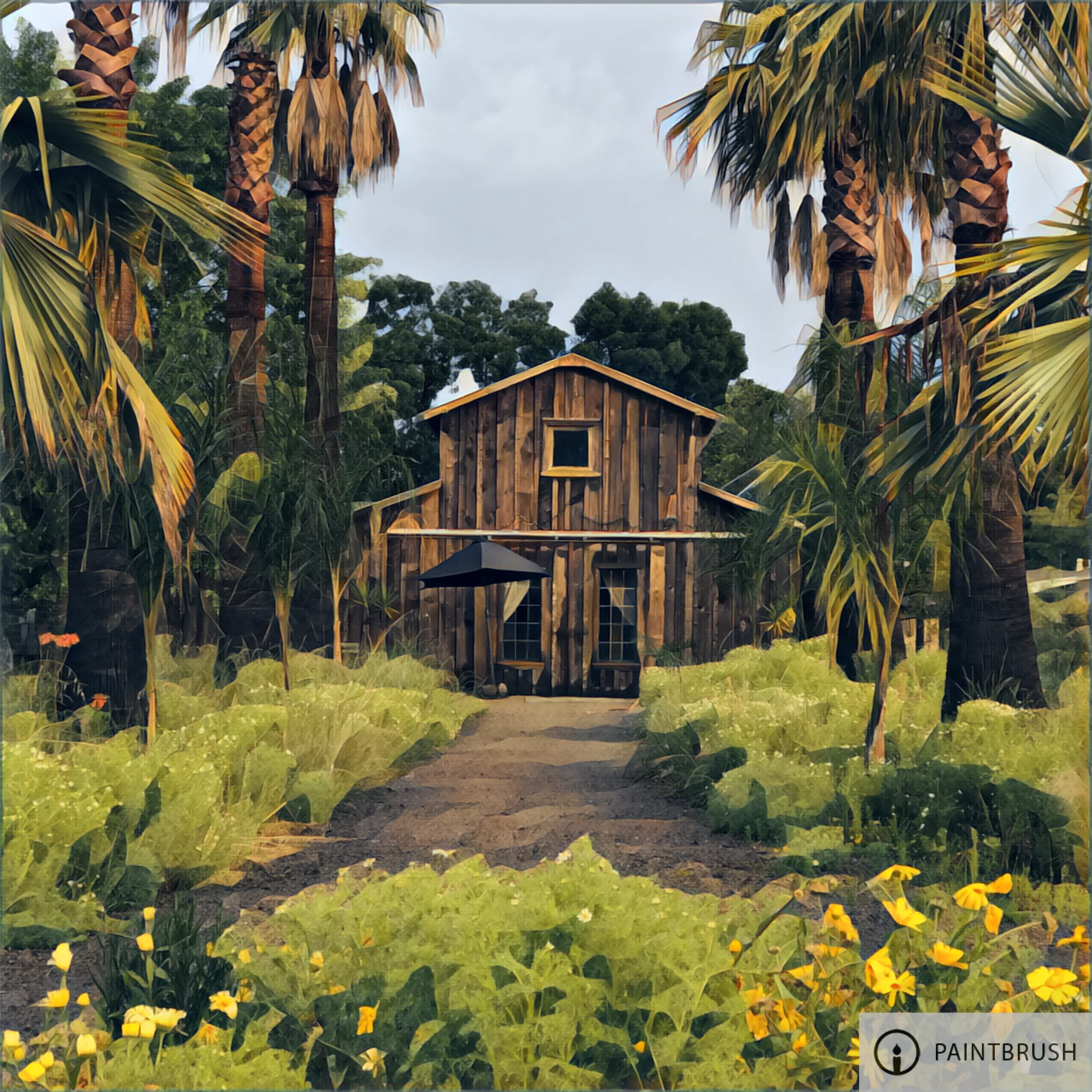 A wooden house surrounded by tall palm trees and lush green plants leads to a dirt pathway.