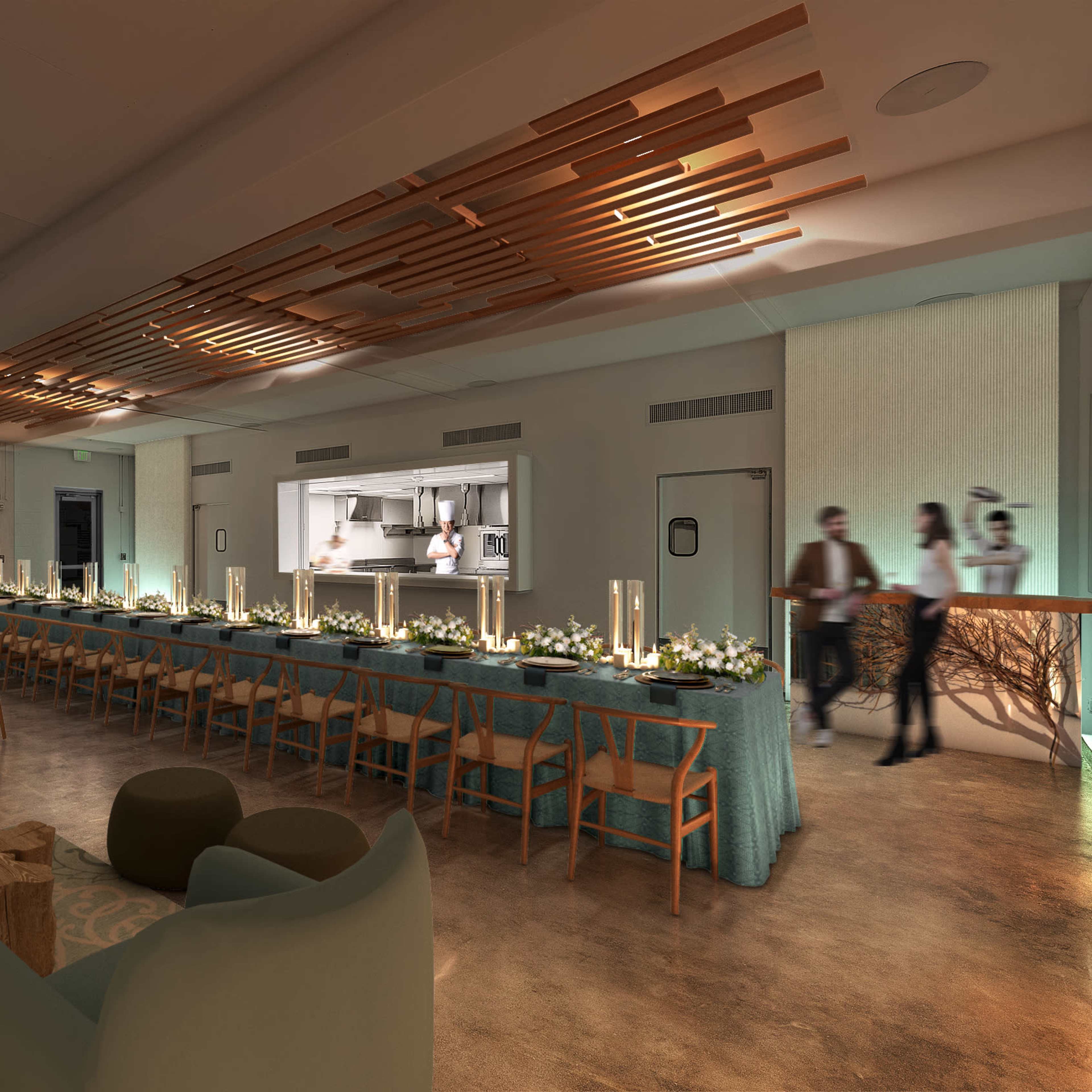 A spacious lounge area with tables set for dining, soft seating, and a kitchen visible in the background.