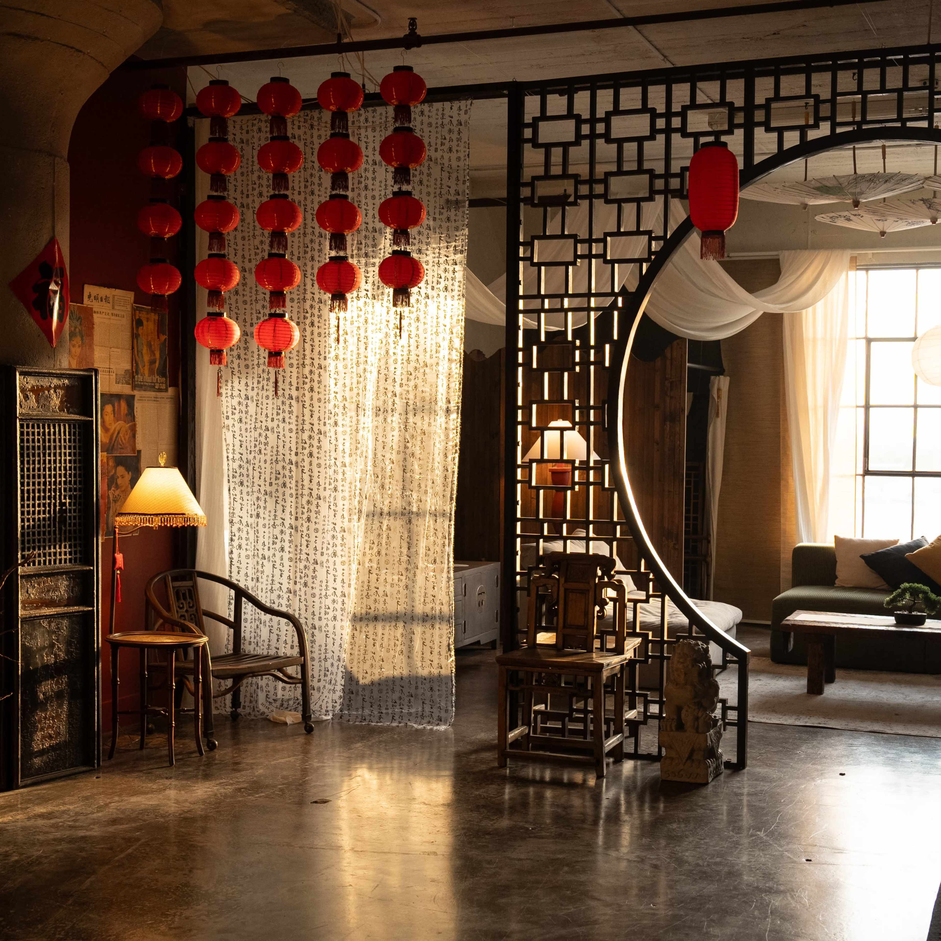 A spacious room with a circular doorway, traditional decorative elements, and soft lighting.