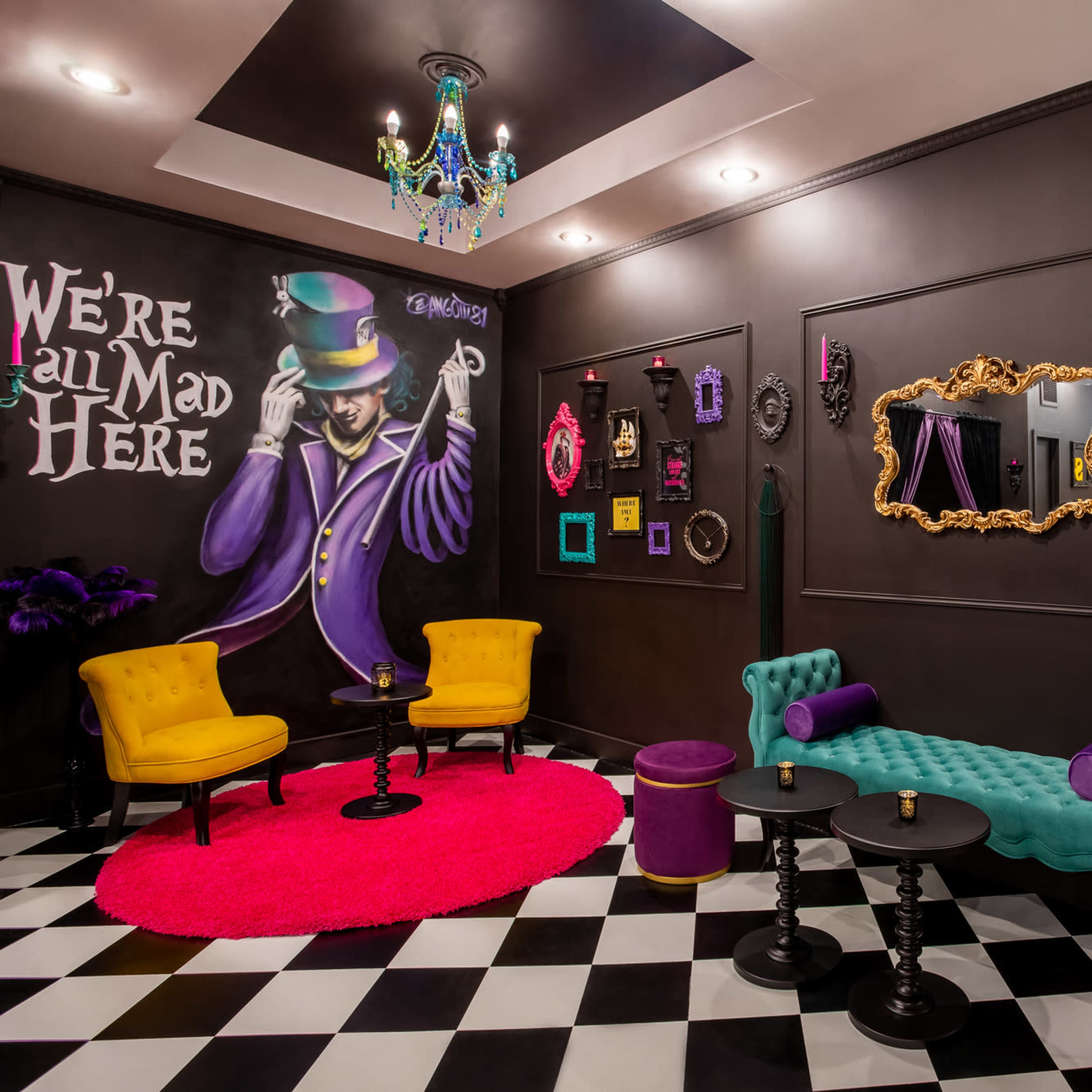 A vibrant room with a black and white checkered floor, featuring yellow and turquoise seating, and eclectic wall decor, including a whimsical mural and framed mirrors.