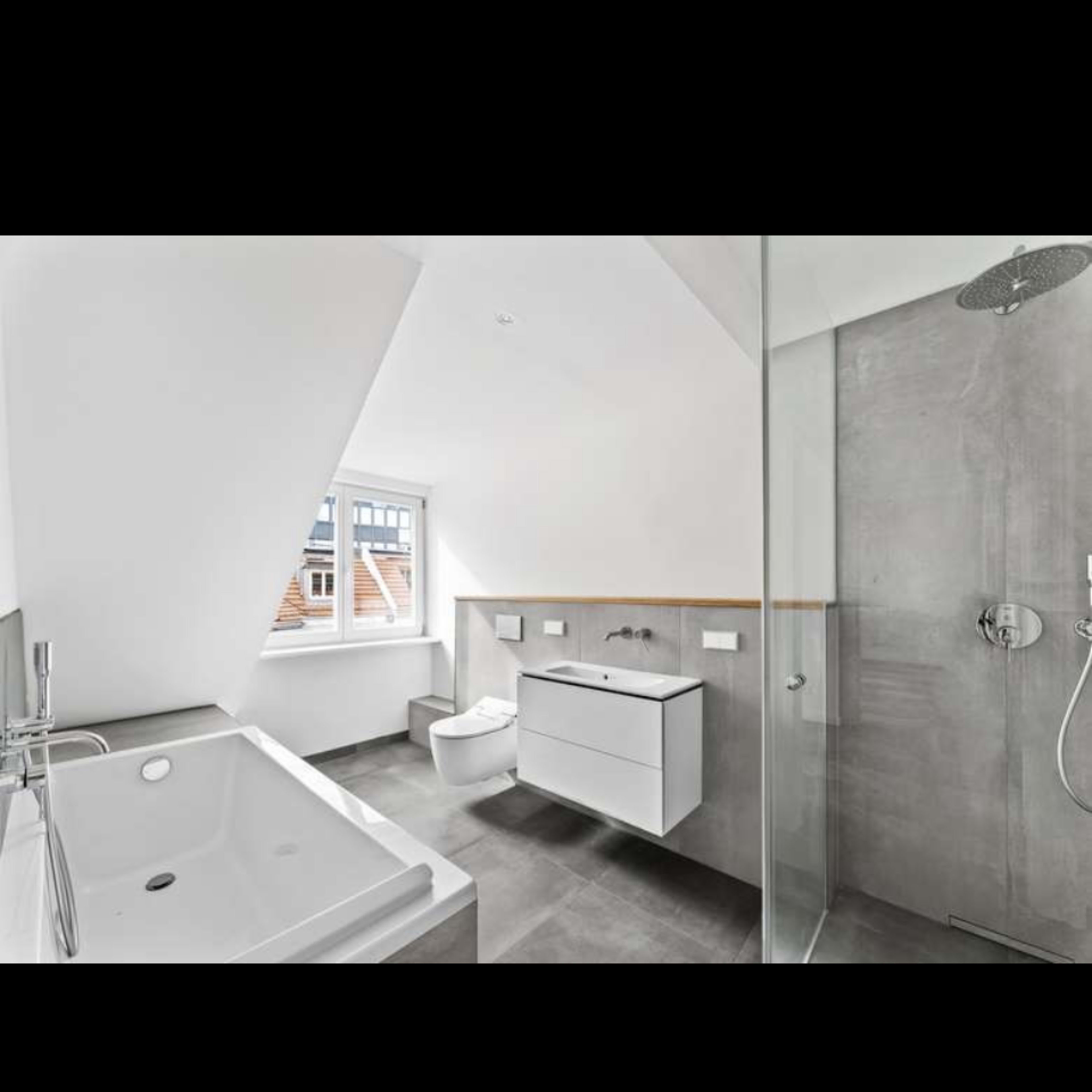 A modern bathroom featuring a bathtub, a shower area, a toilet, and a vanity with a sink against a minimalist design with light walls and gray accents.