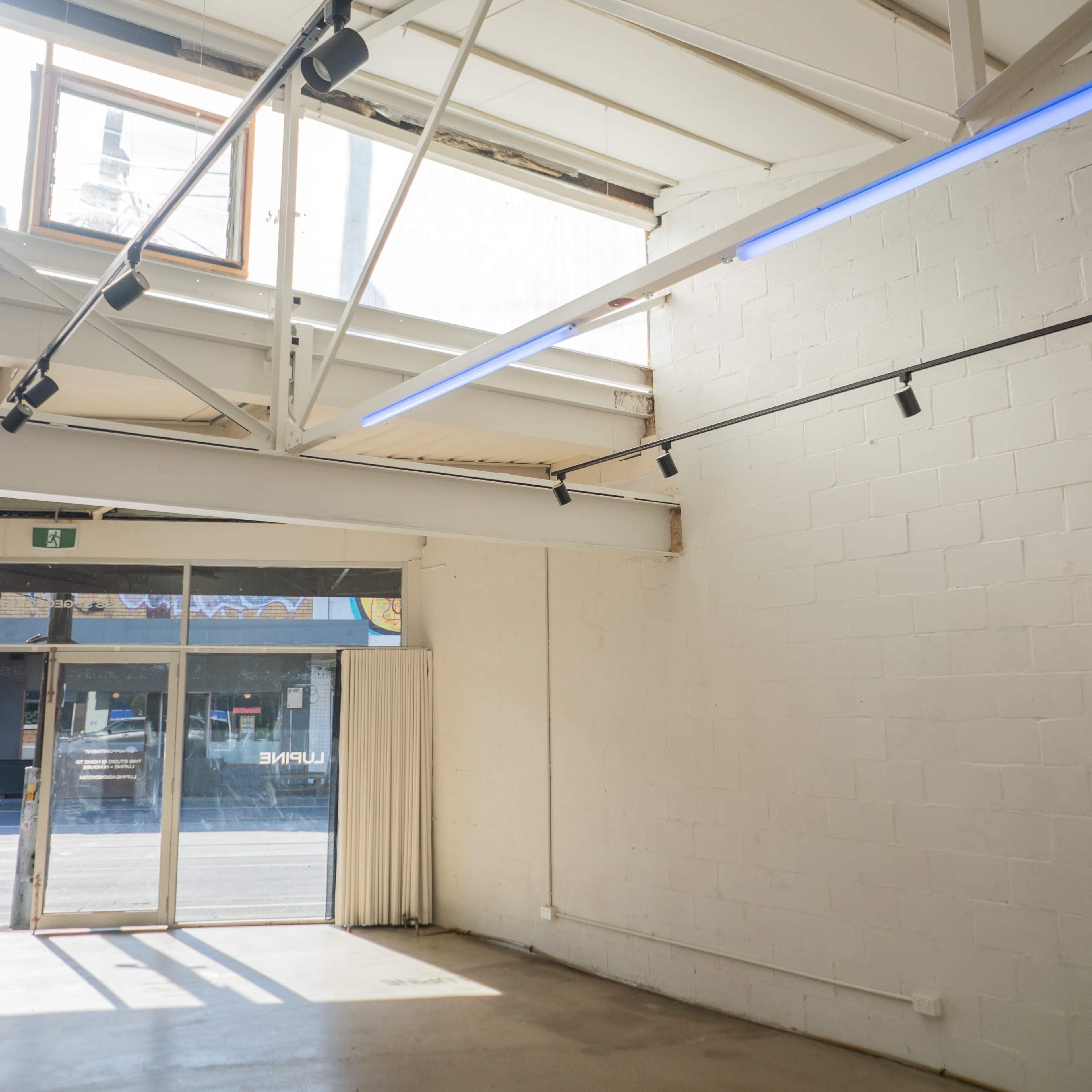 A spacious, empty interior with large windows allowing natural light to enter.